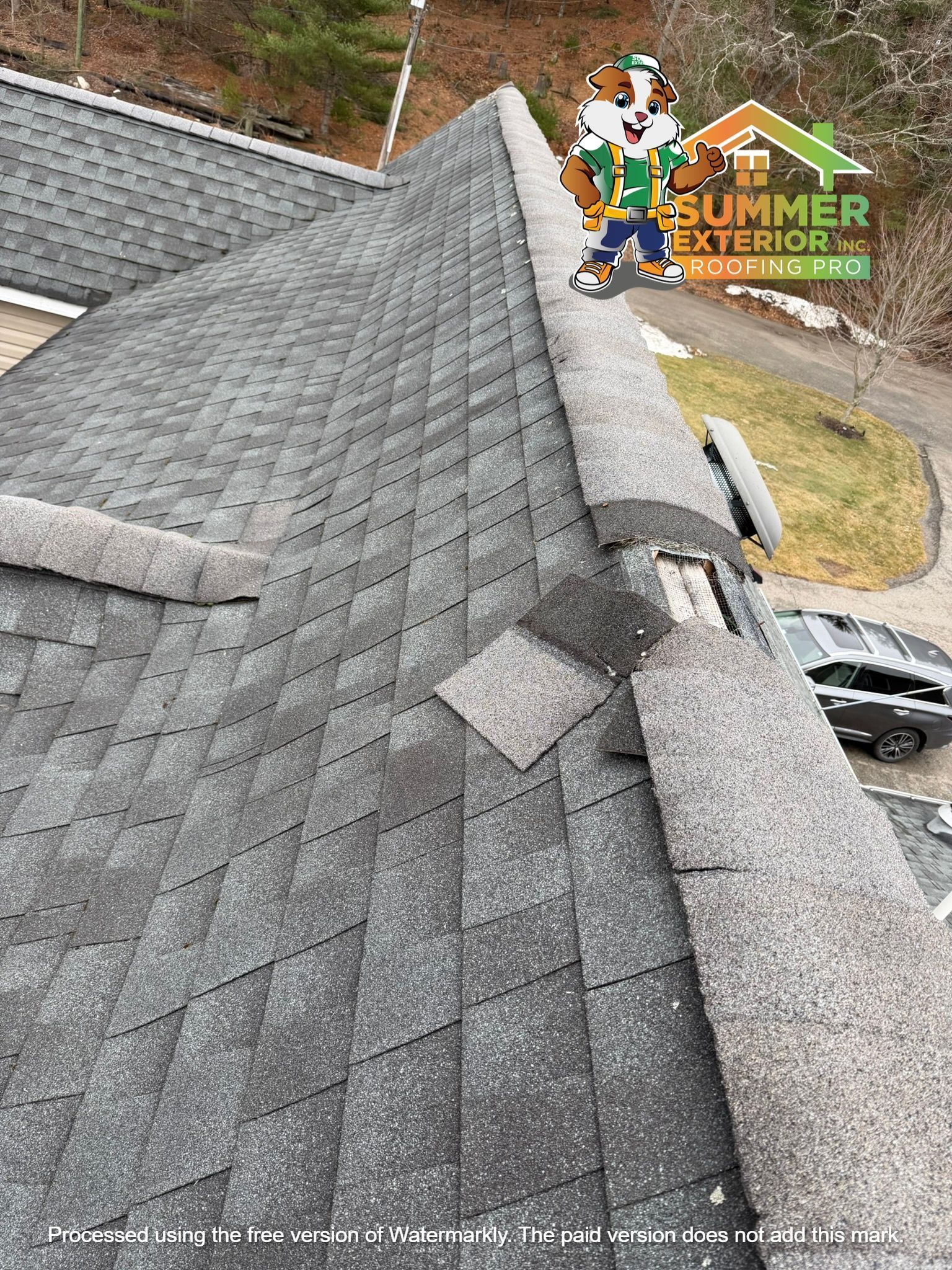 A high-angle view of a grey shingled roof with a damaged ridge cap and a mascot overlay for Summer Exterior.