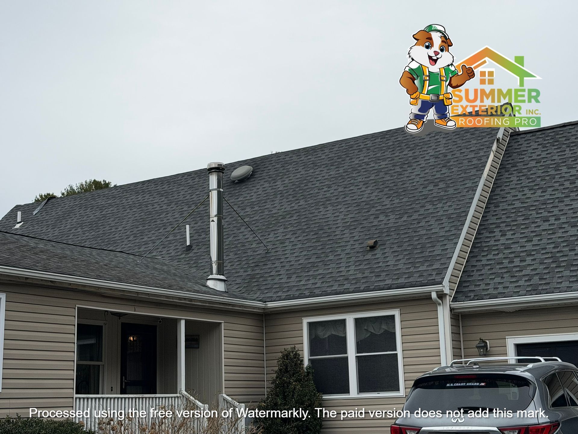A house exterior with a grey shingled roof, beige siding, and a mascot logo of a cartoon beaver in the upper right corner.