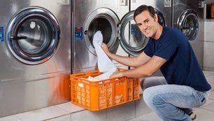 Man putting clothes in laundry machine