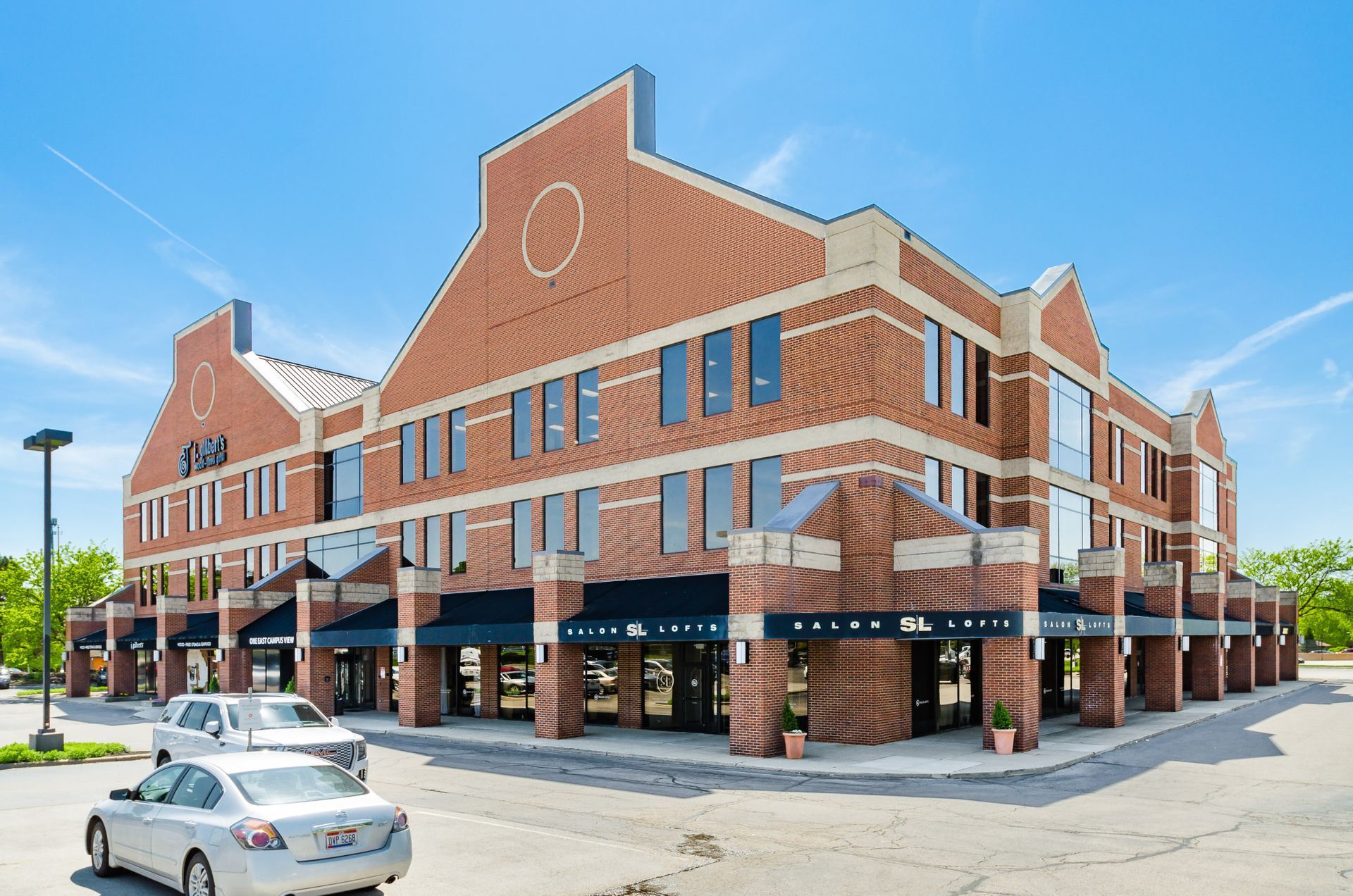 A large brick building with cars parked in front of it