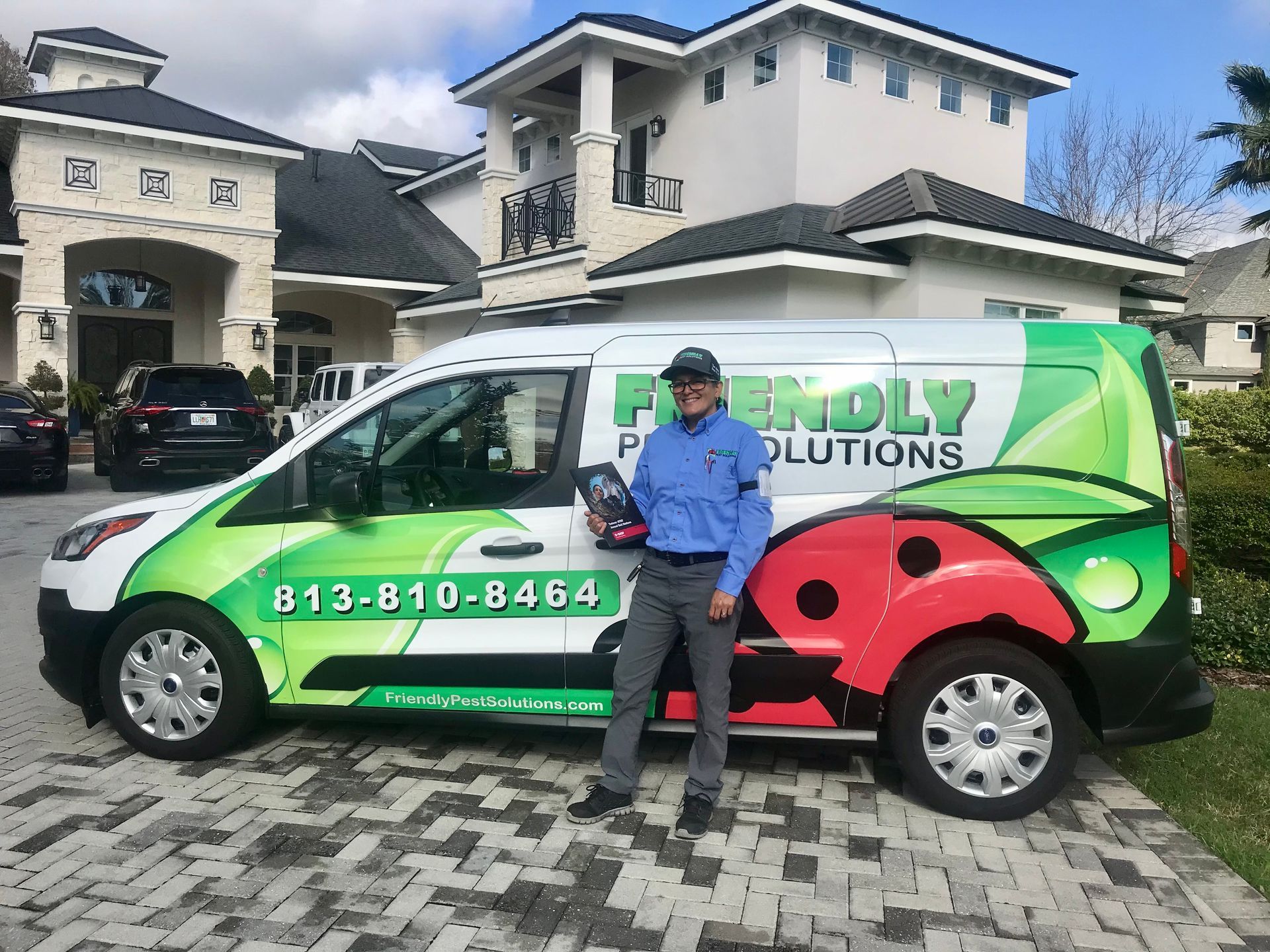 Pest control worker spraying insecticide in a kitchen.
