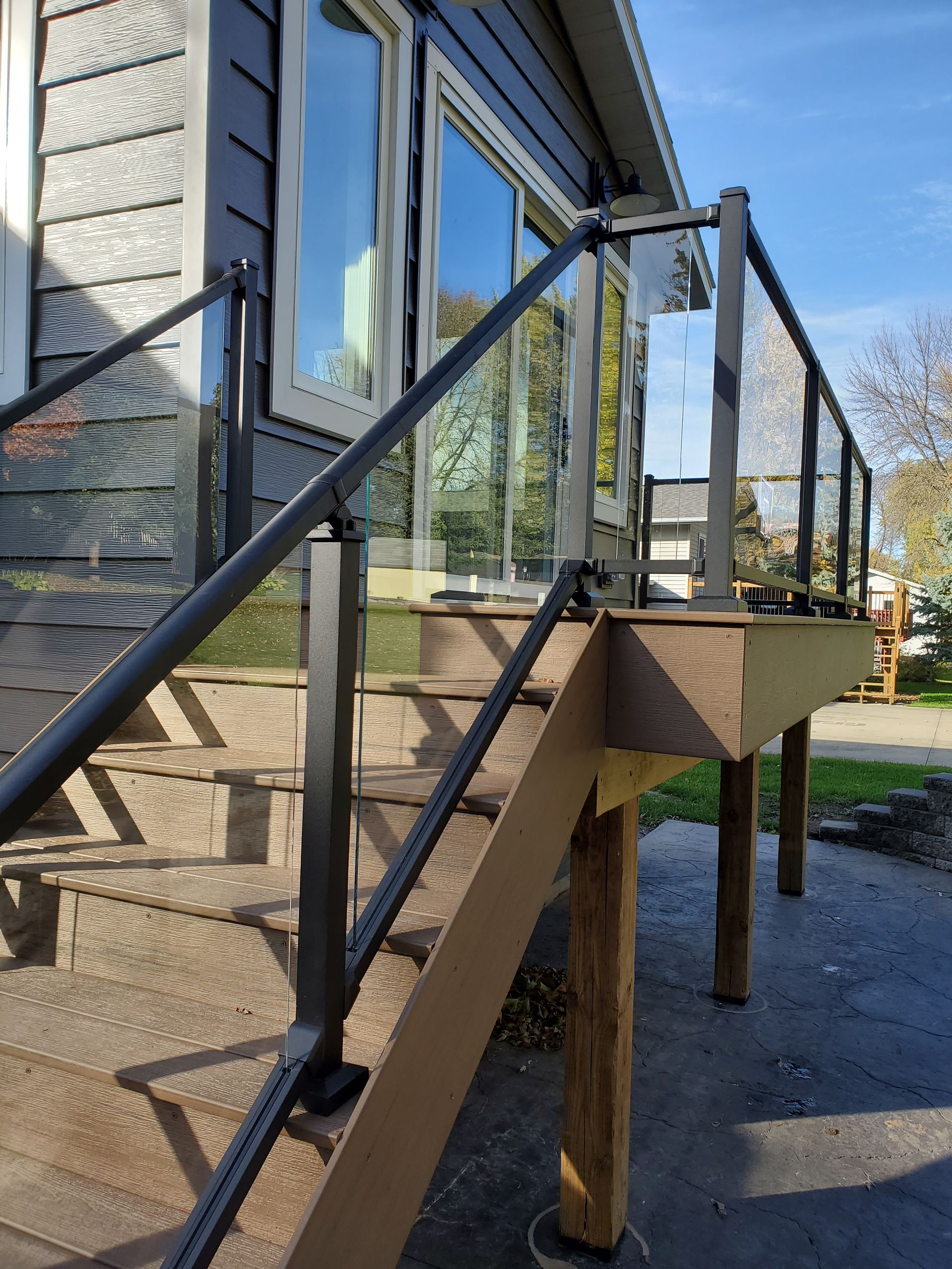Stairs leading up to a deck with a glass railing