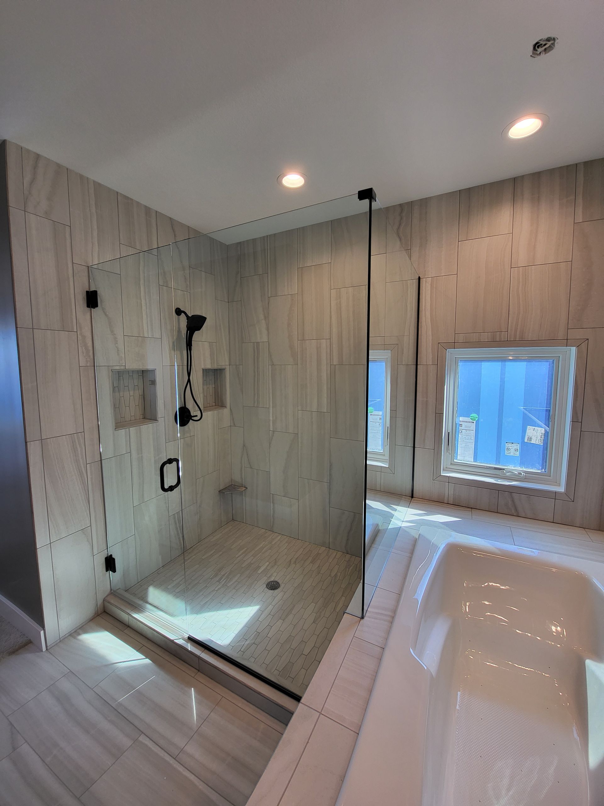 A bathroom with a walk in shower and a bathtub