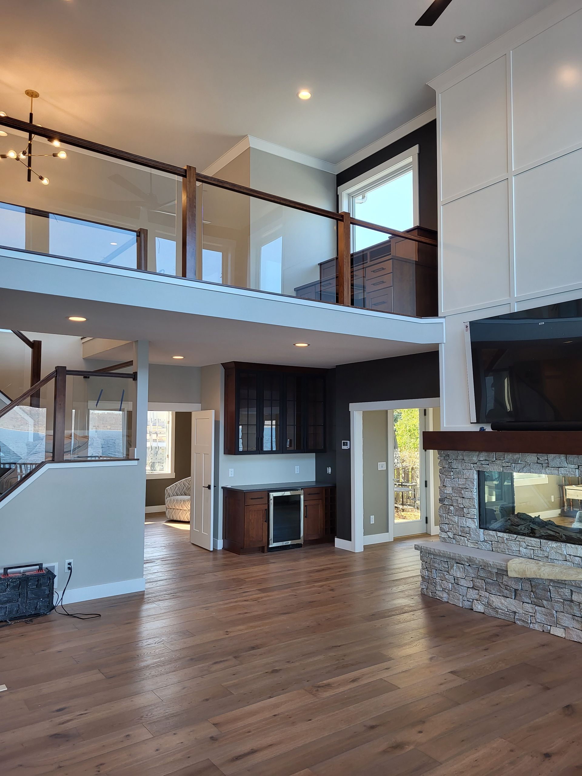 A large living room with hardwood floors and a fireplace