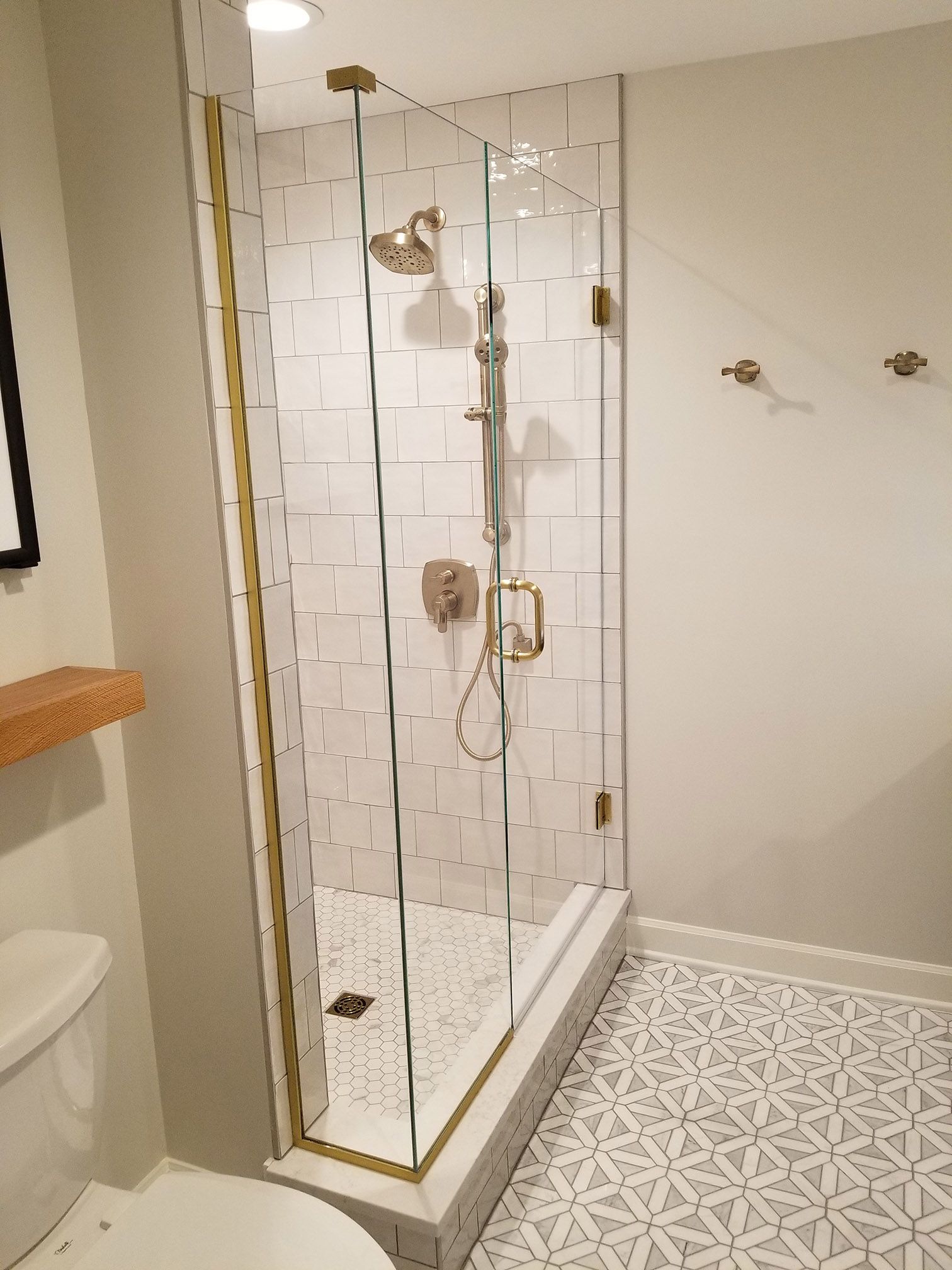 A bathroom with a walk in shower and a toilet