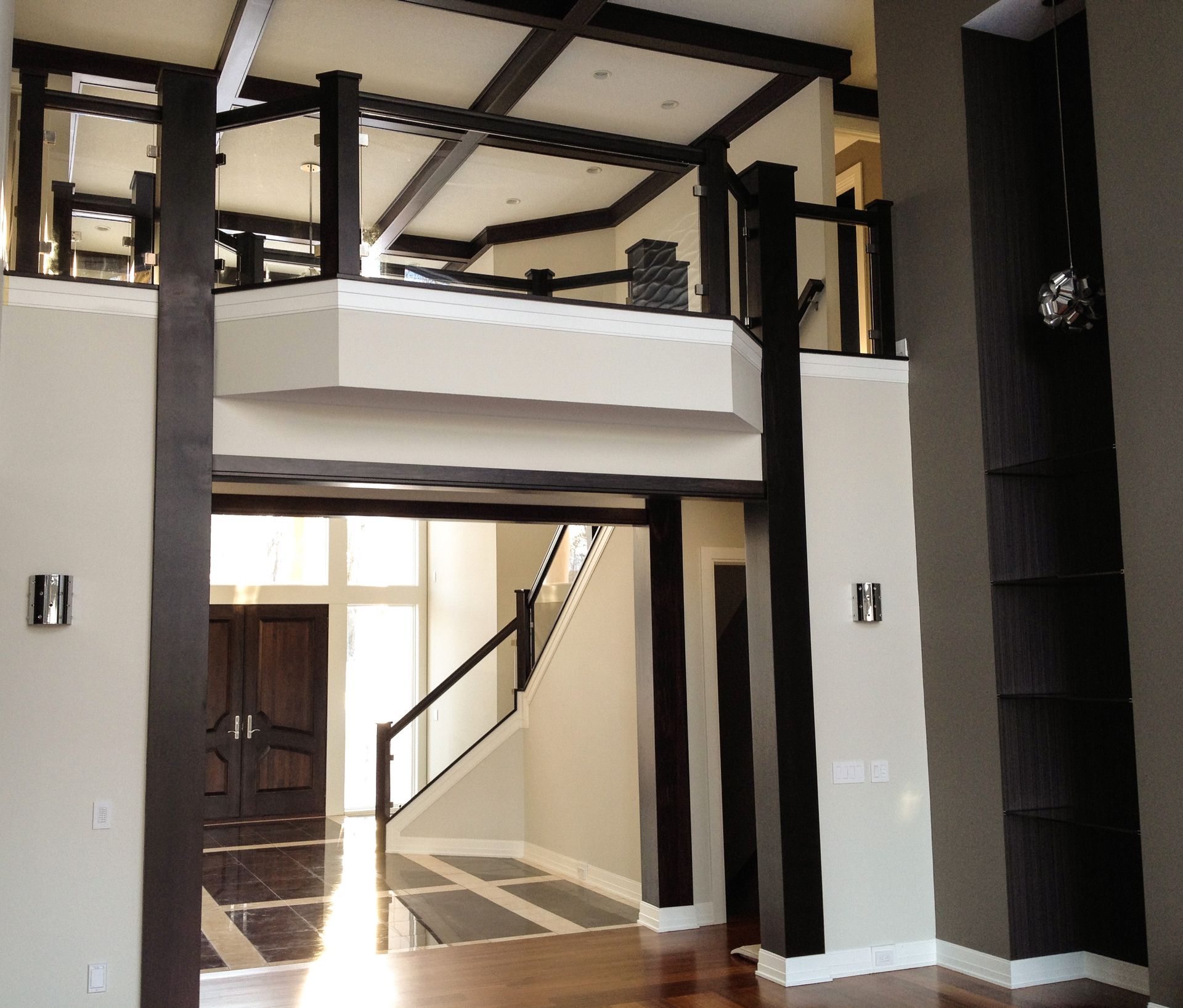 A large room with a staircase and a balcony