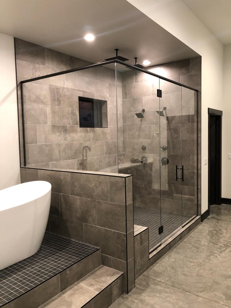 A bathroom with a bathtub and a walk-in shower