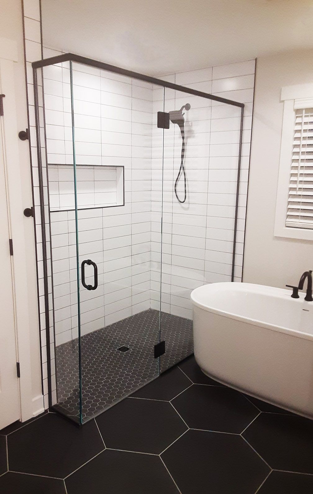 A bathroom with a walk in shower and a bathtub