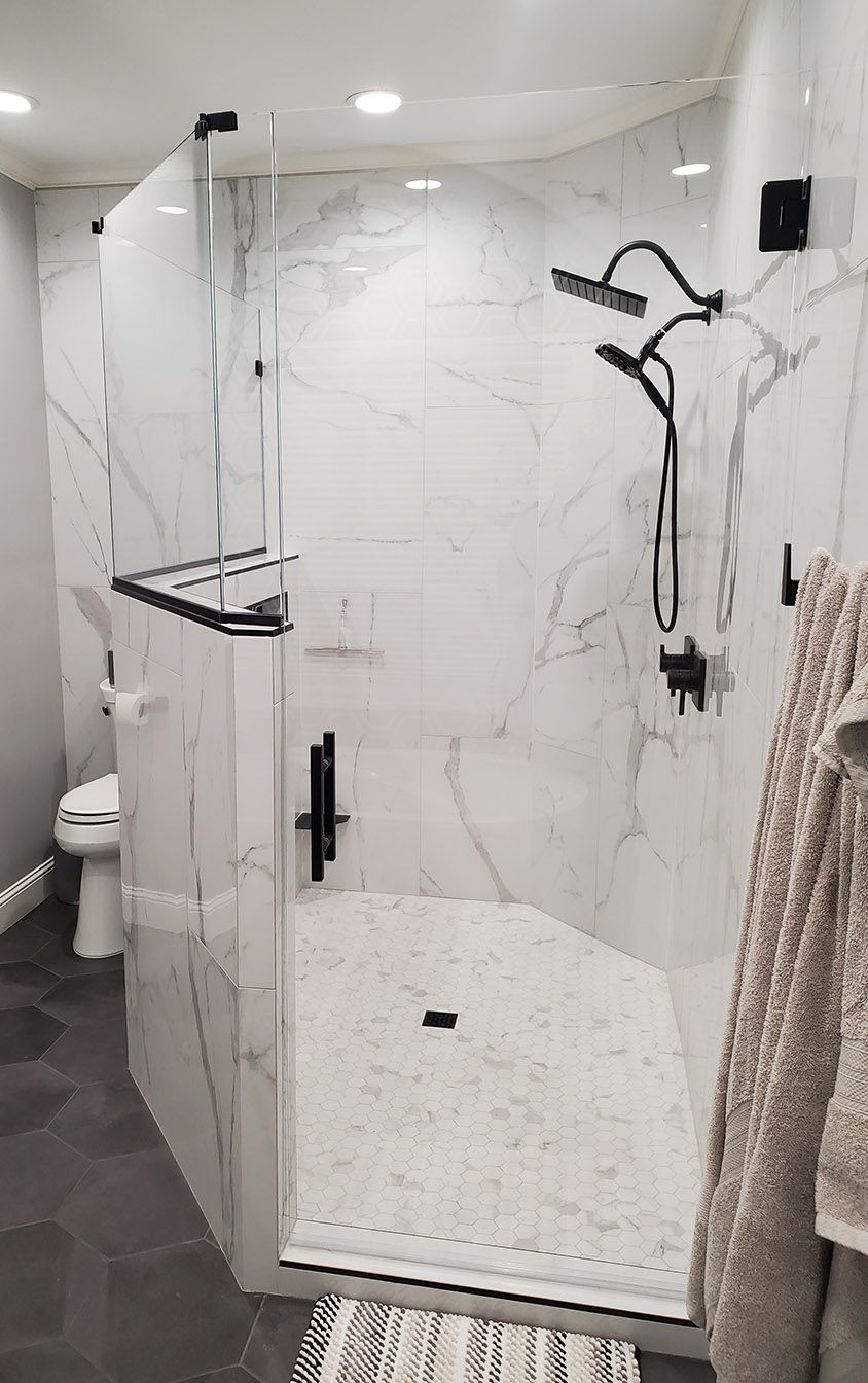 A bathroom with a walk in shower and a toilet