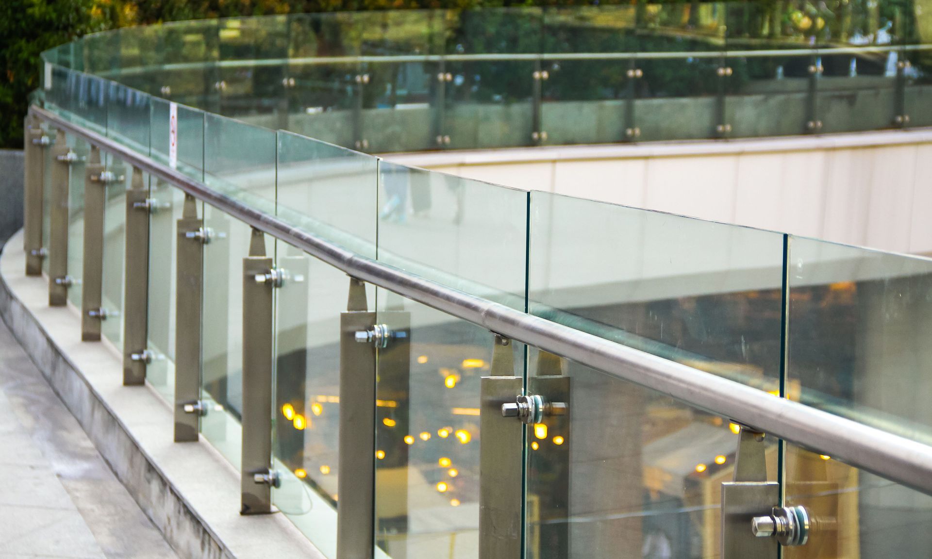a glass railing with a stainless steel railing on a balcony .