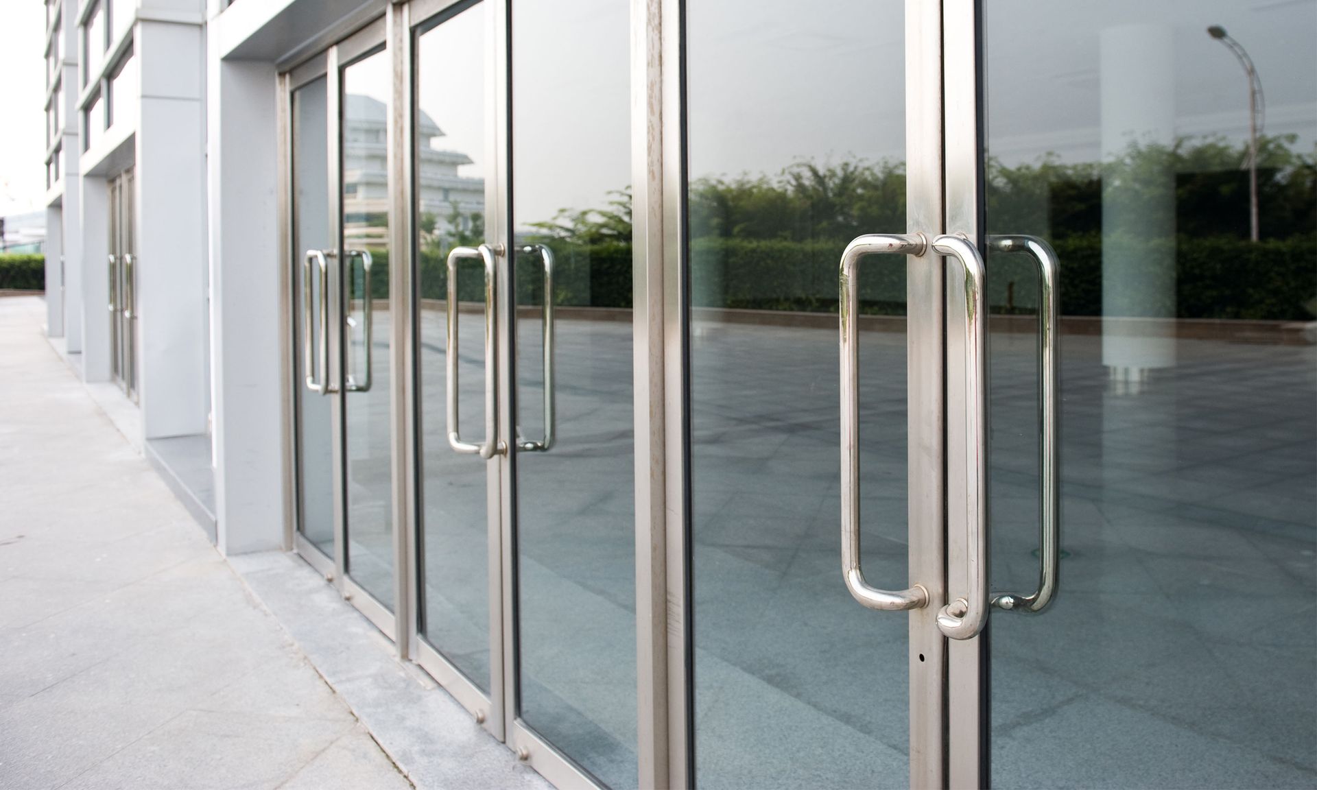 a building with a lot of glass doors and handles