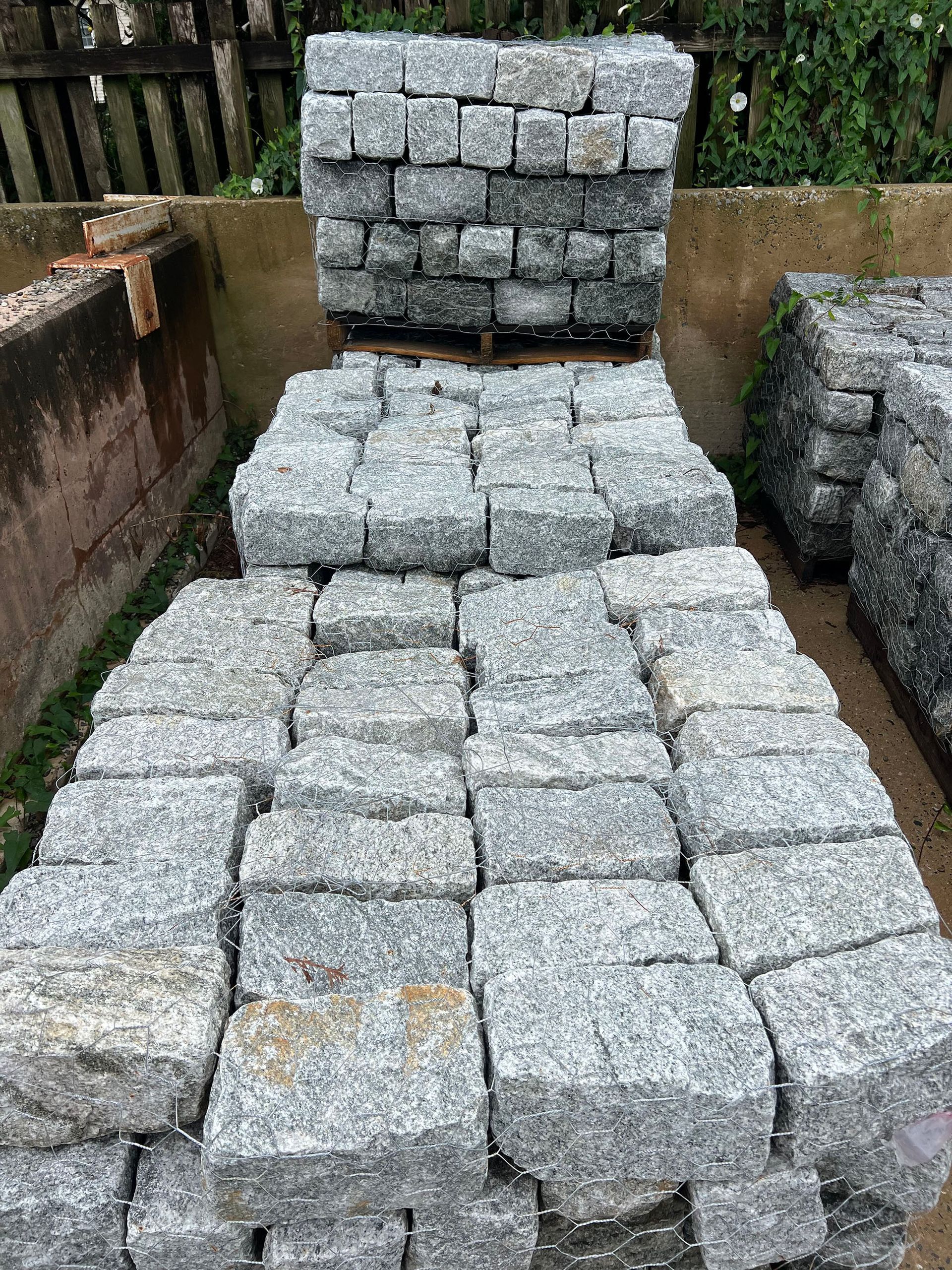 A pile of bricks sitting on top of each other on a pallet.