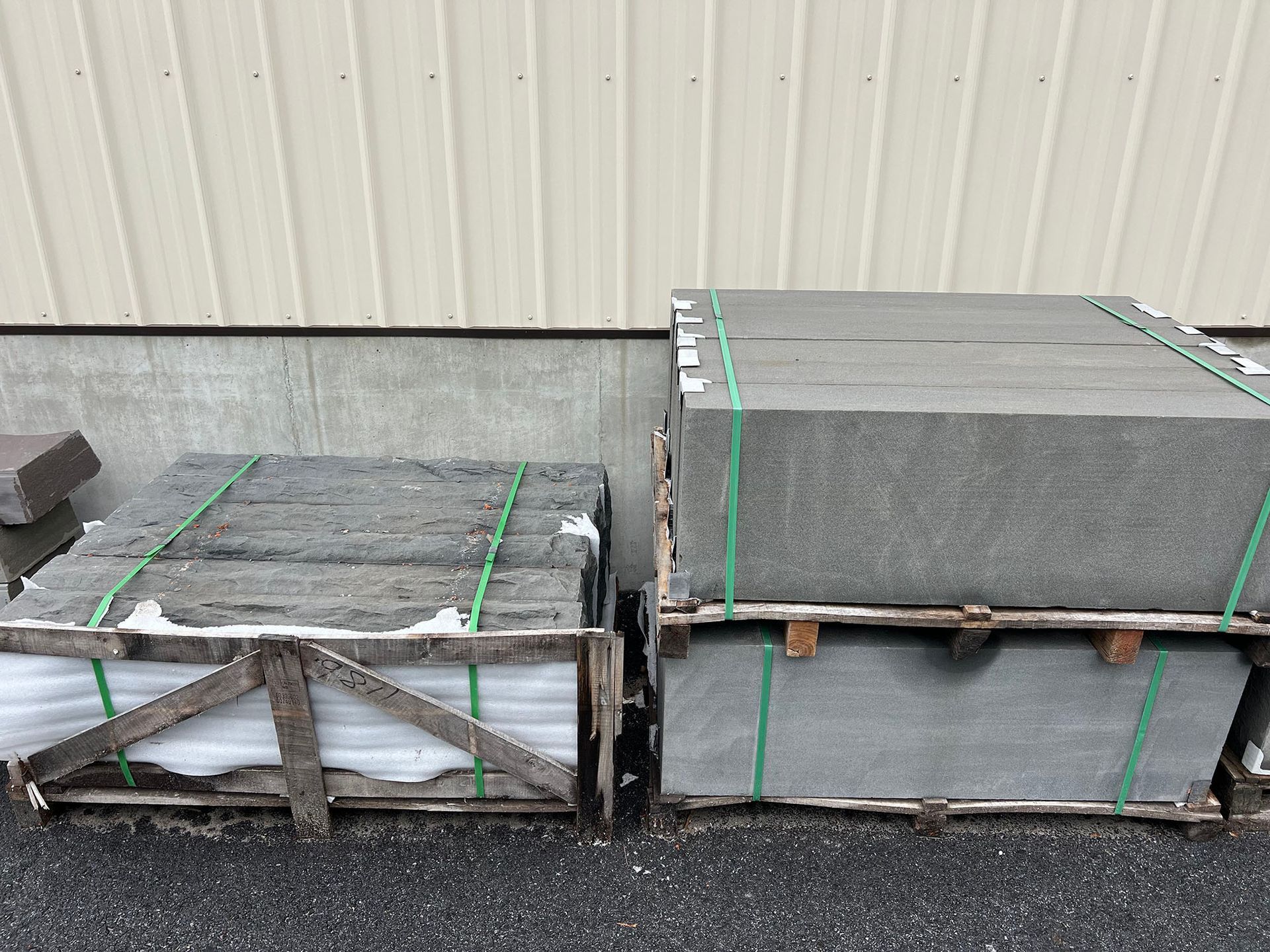 Two wooden crates filled with concrete blocks are stacked on top of each other.