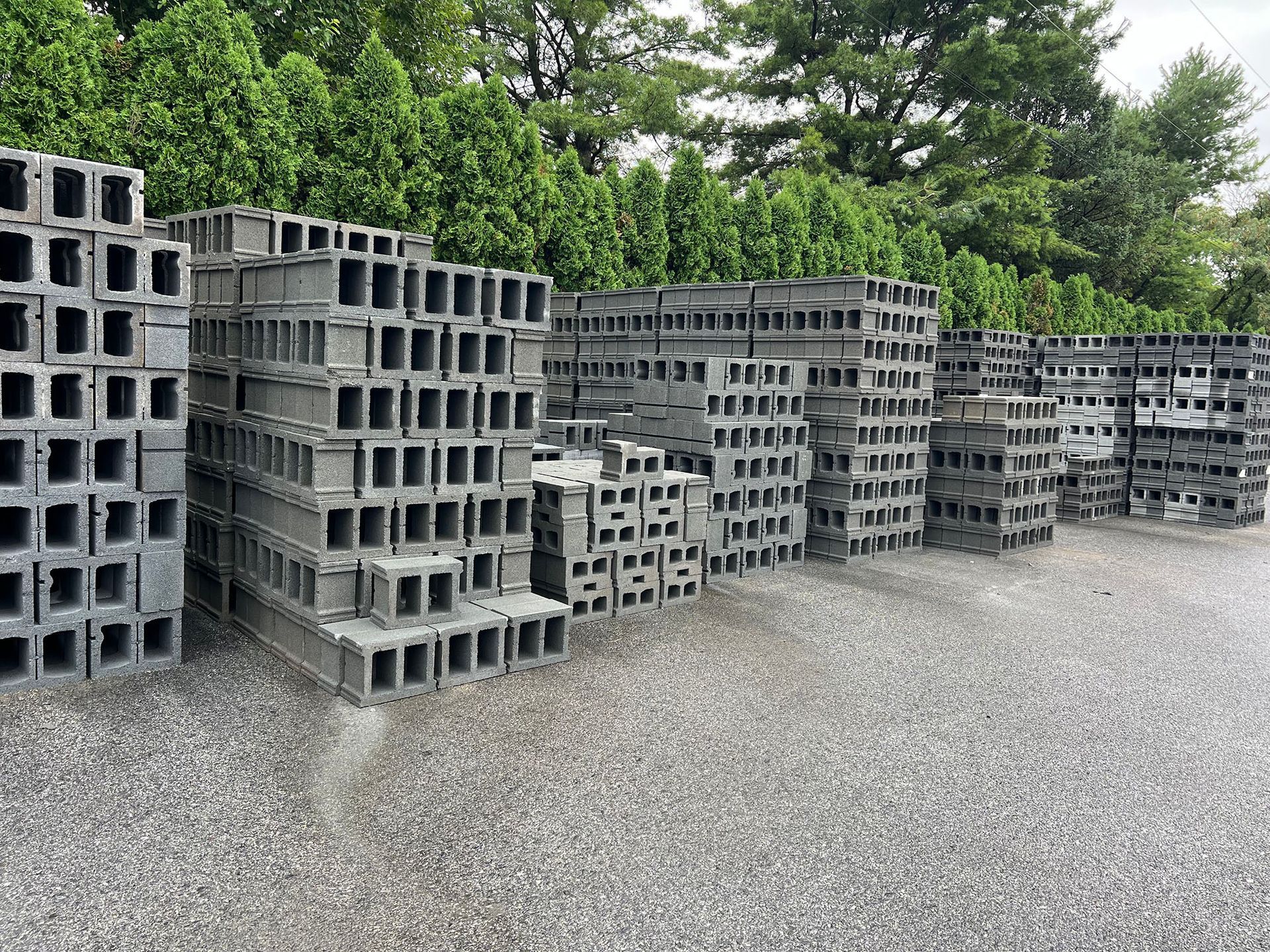 A lot of concrete blocks are stacked on top of each other on the ground.