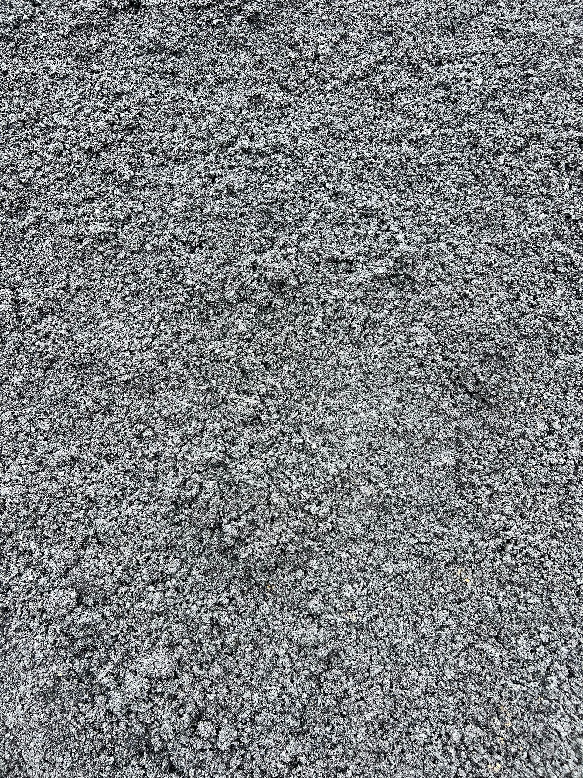 A pile of gravel is sitting on the ground.