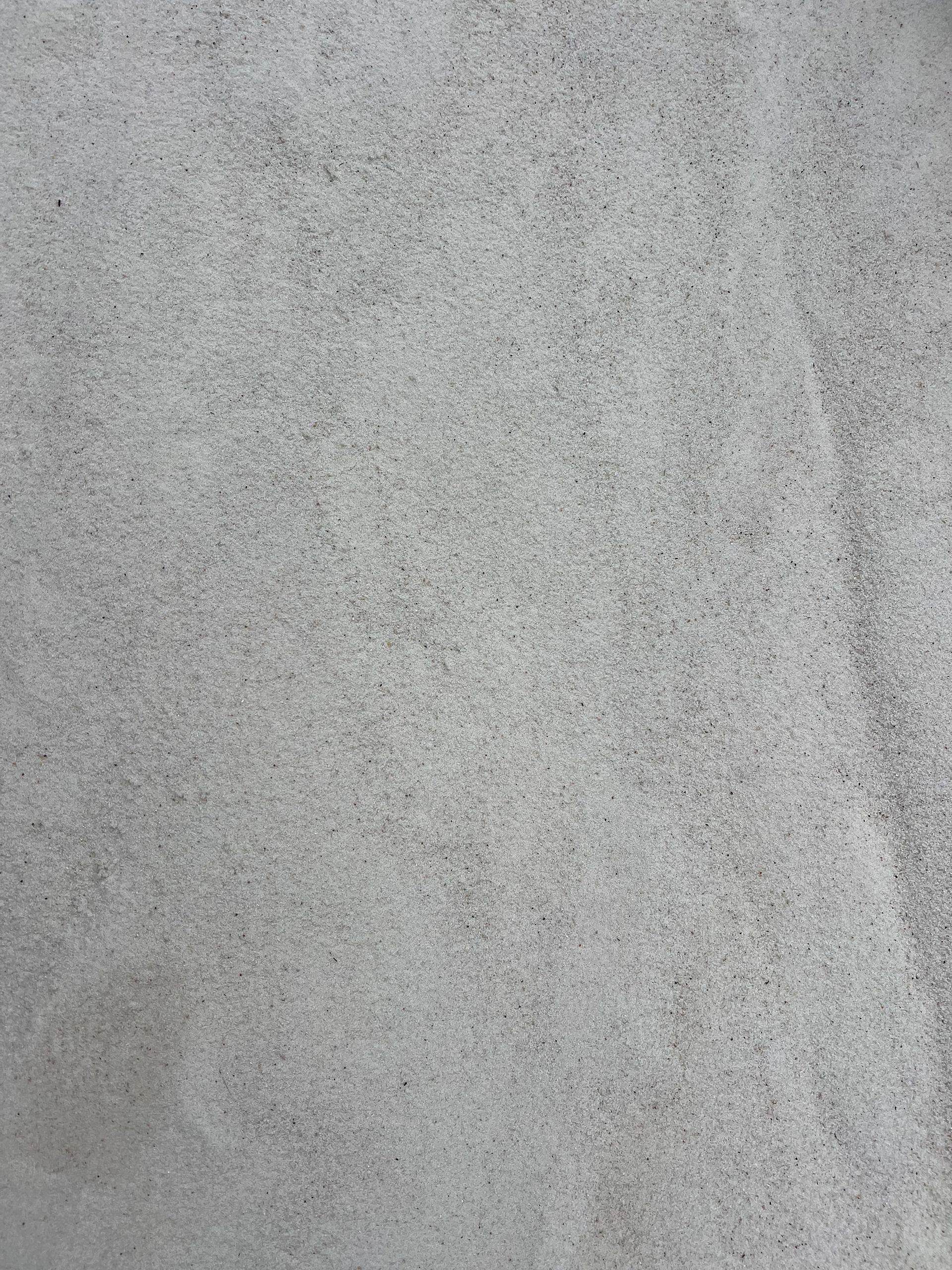 A close up of a white tile with a marble texture.