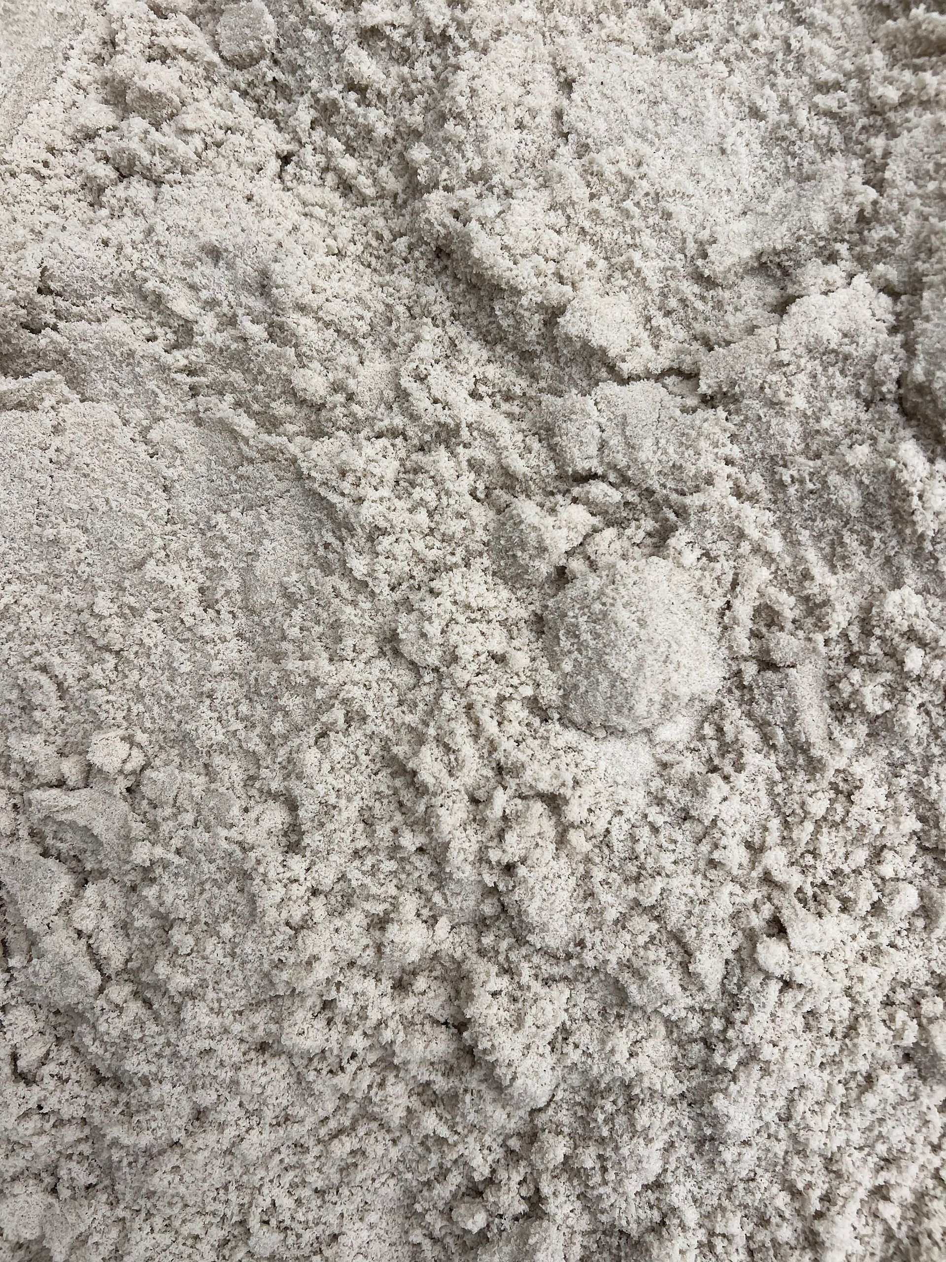 A close up of a pile of white sand.