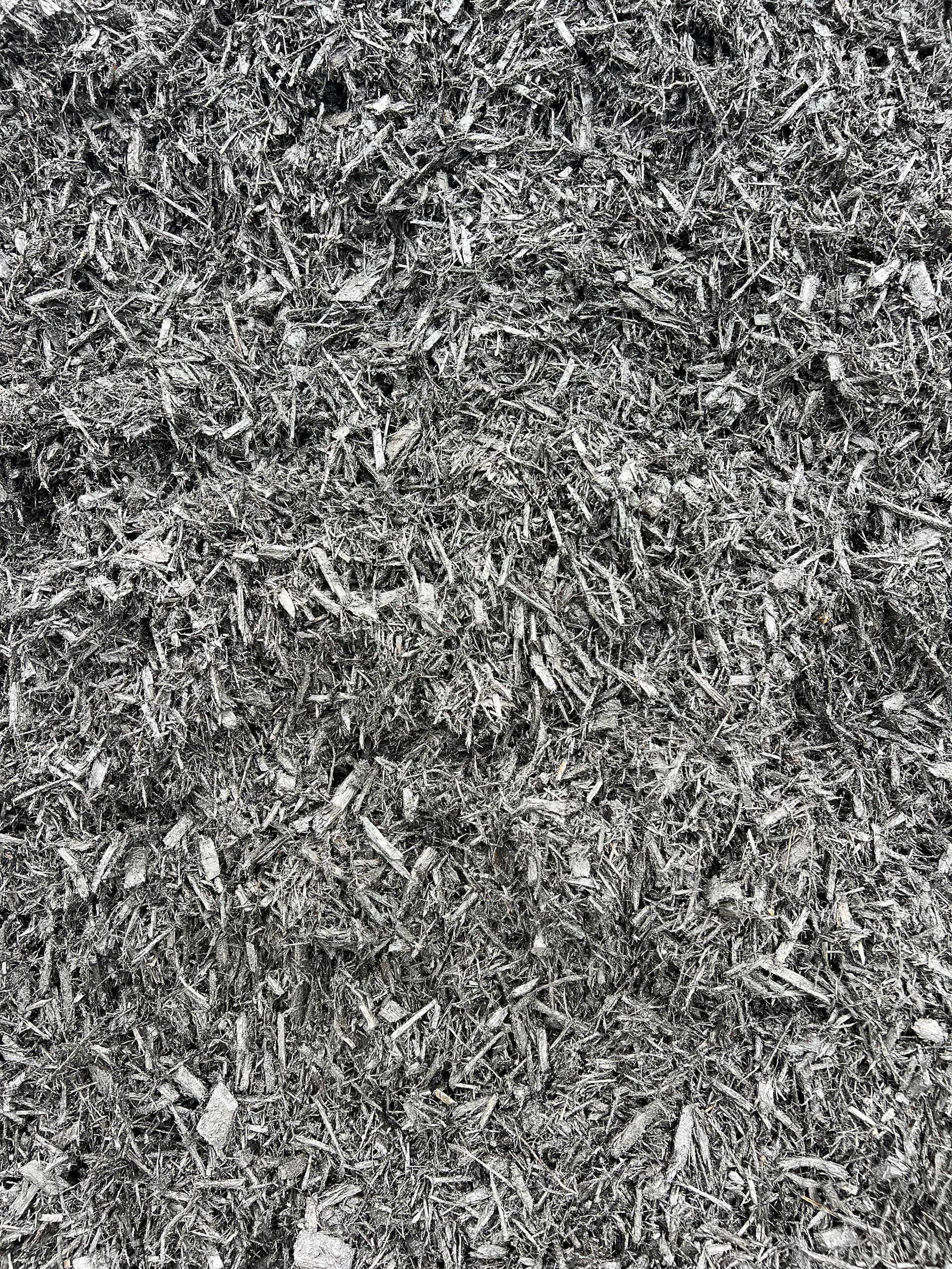 It is a black and white photo of a pile of mulch.