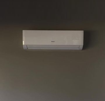 A white air conditioner is hanging on a wall.