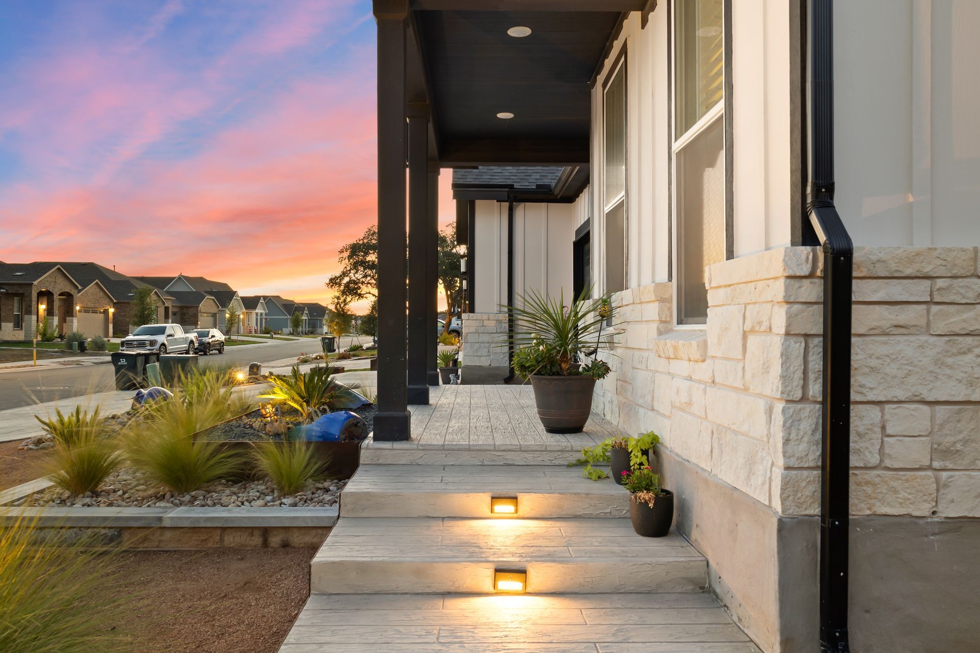 A house with a porch and stairs leading up to it.