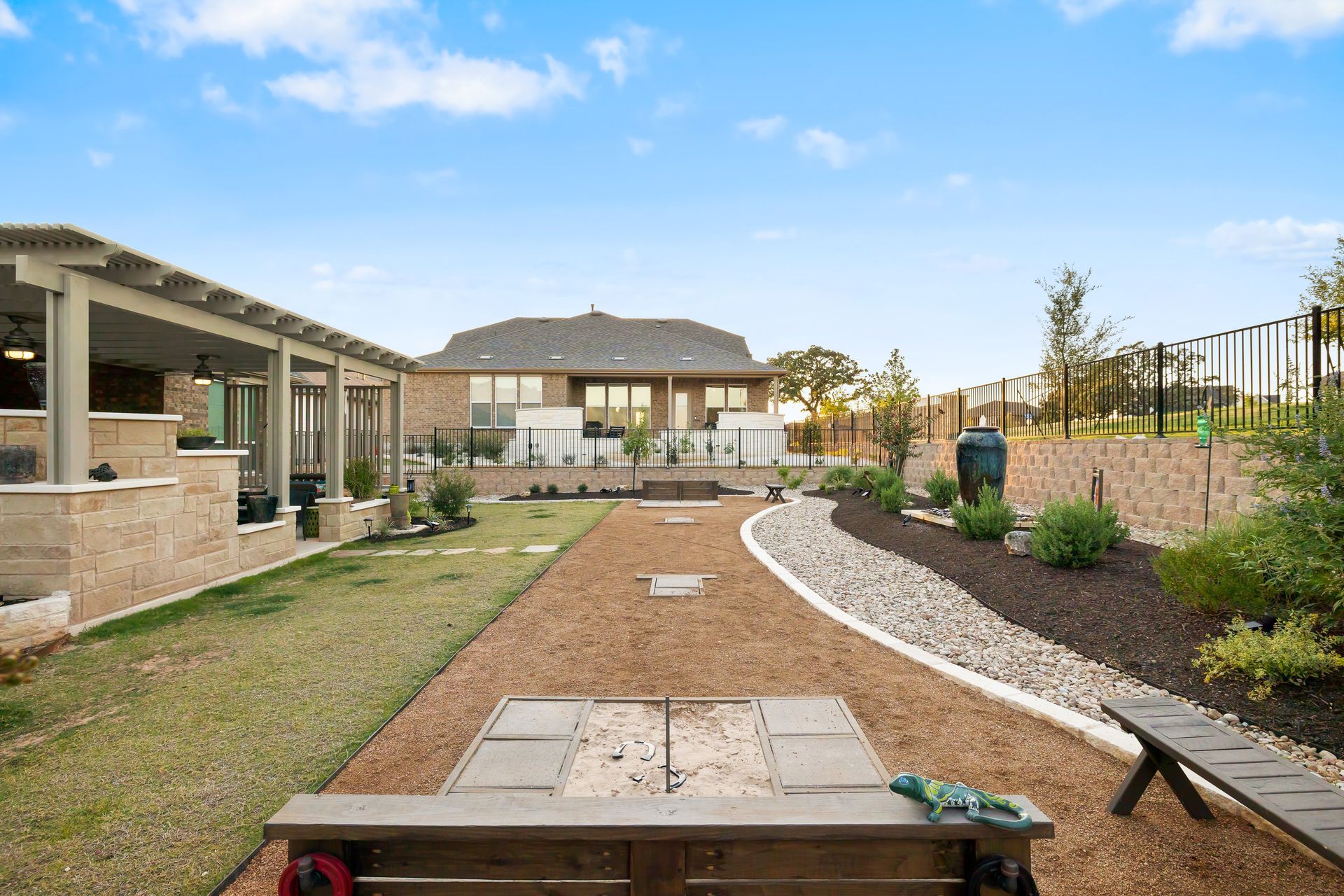 There is a dog park in the backyard of a house.