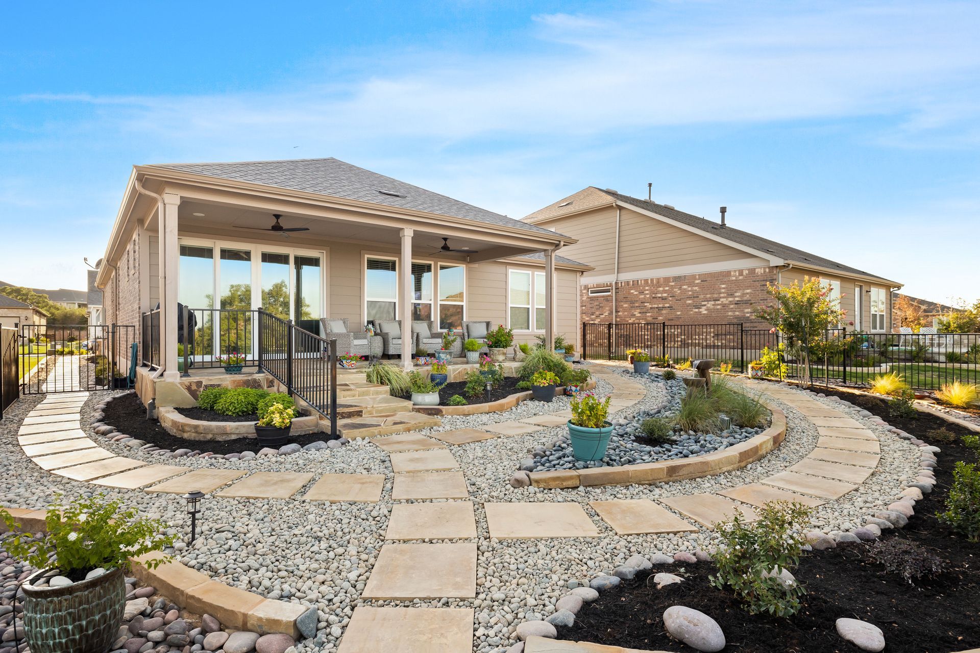 A house with a patio and a walkway in front of it.