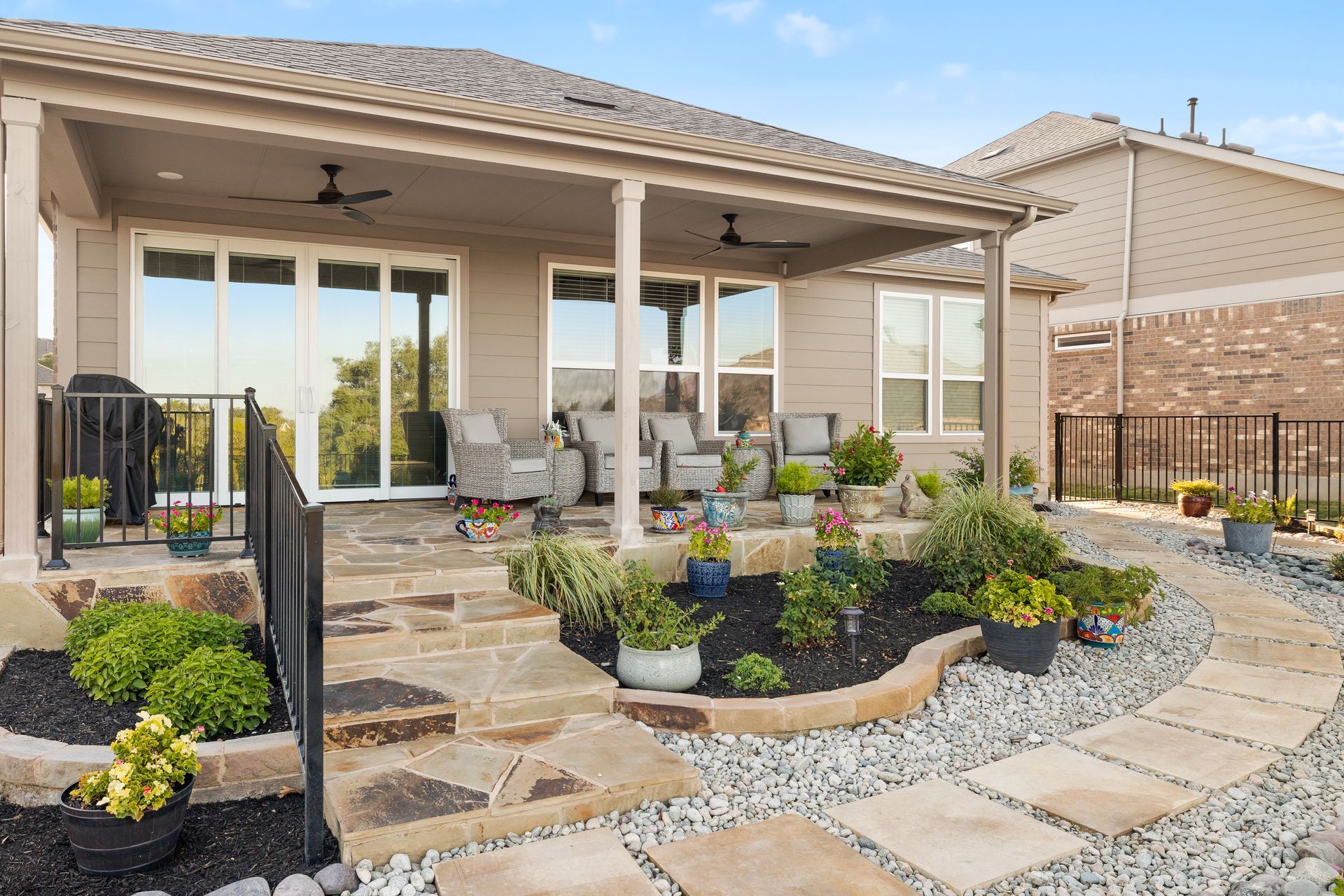 A house with a patio and a walkway in front of it.