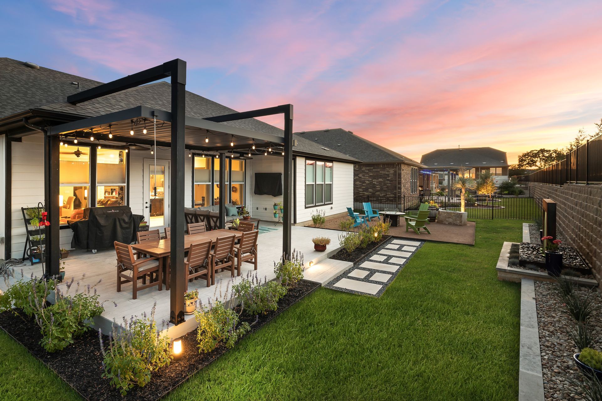 A house with a patio and a pergola in the backyard.