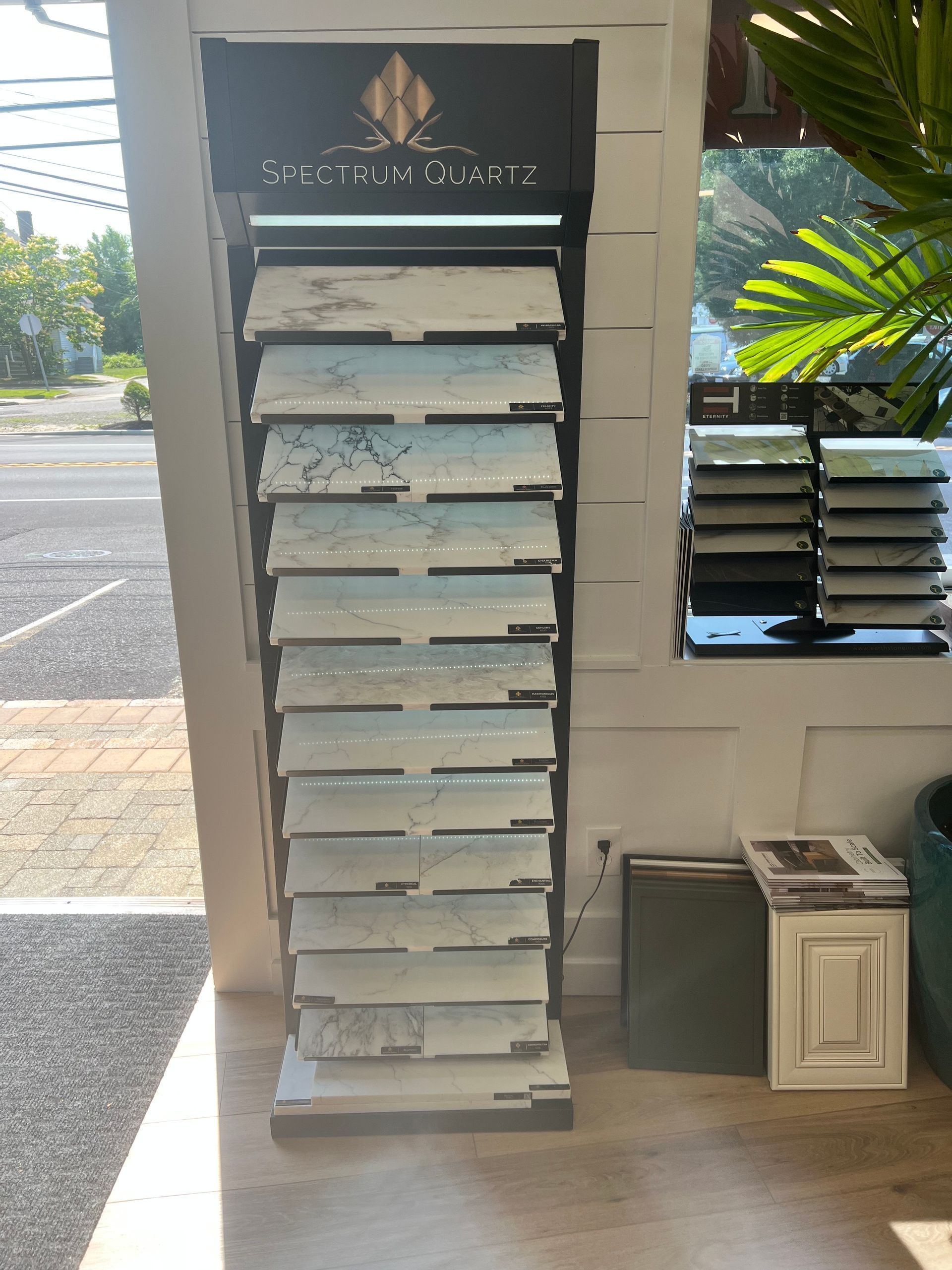 Display stand showcasing various stone samples in a shop window.