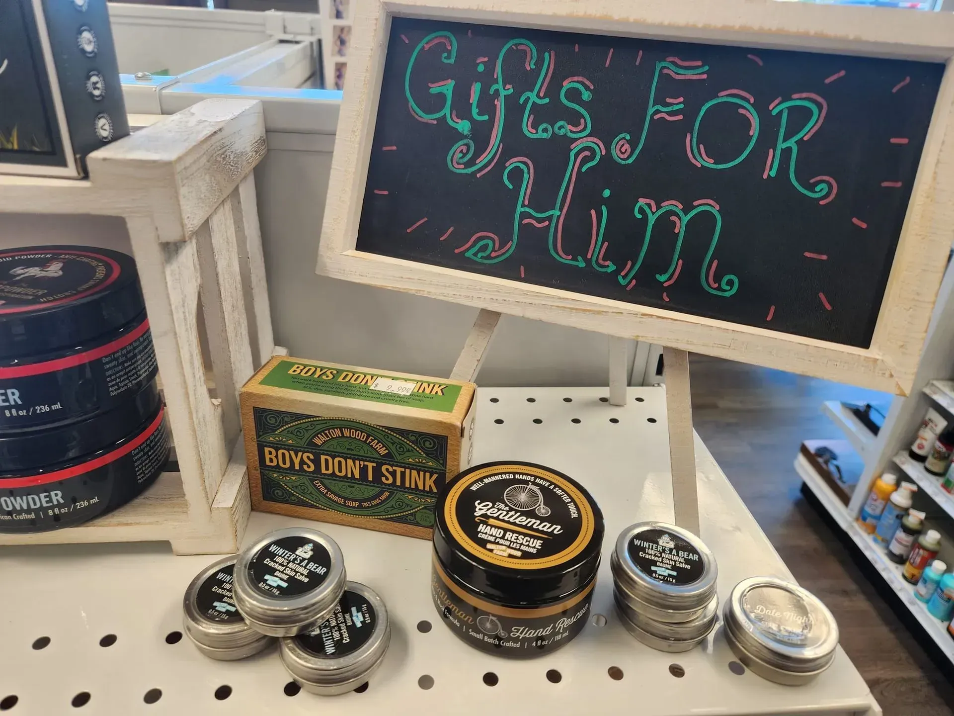Shelf display with men's grooming products, including pomade, with a 