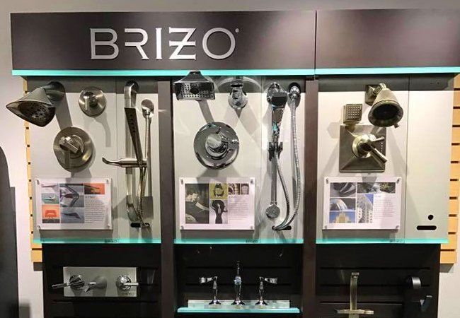 A display of brizo shower heads and faucets in a store