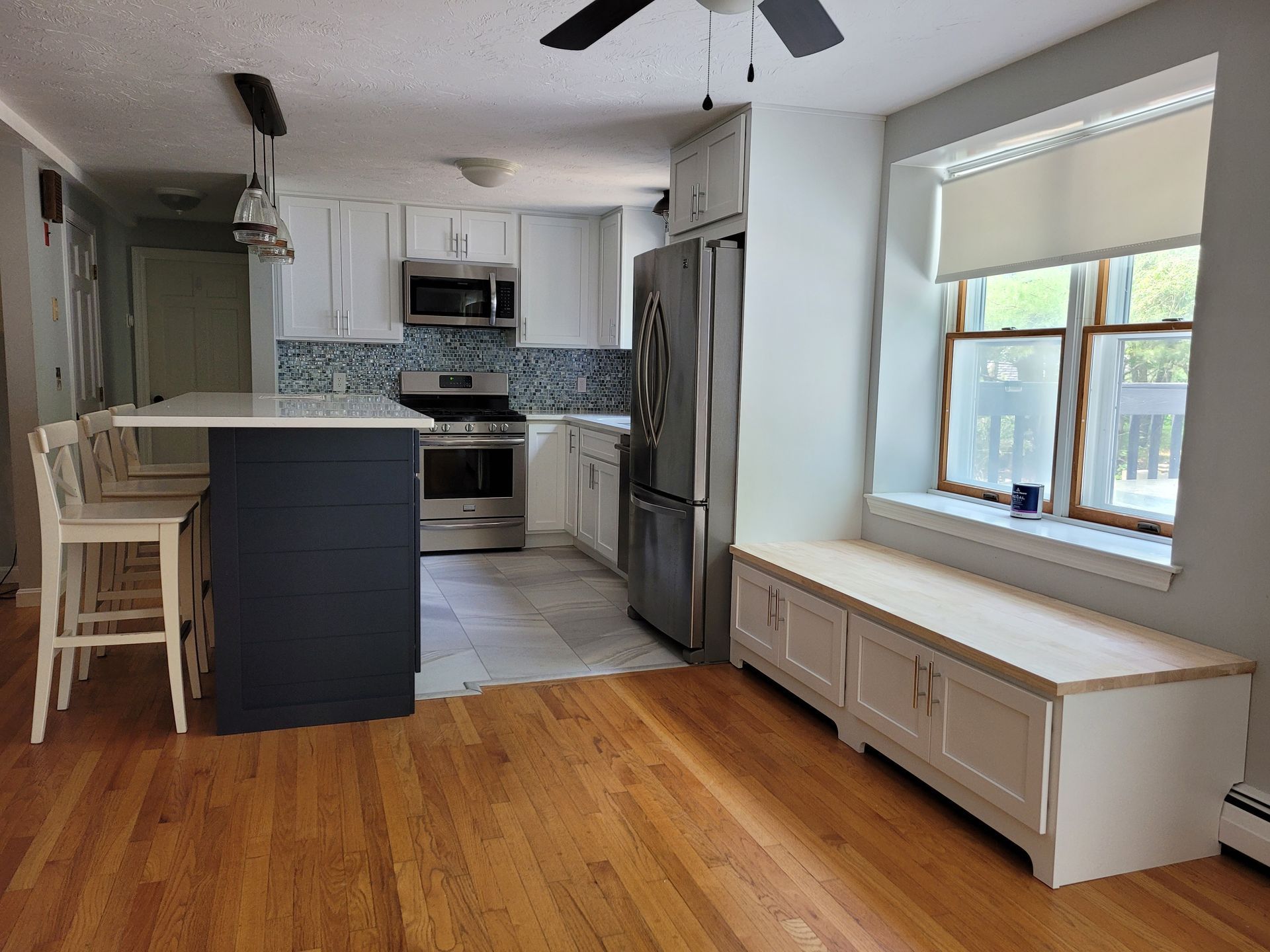 A kitchen with stainless steel appliances and hardwood floors