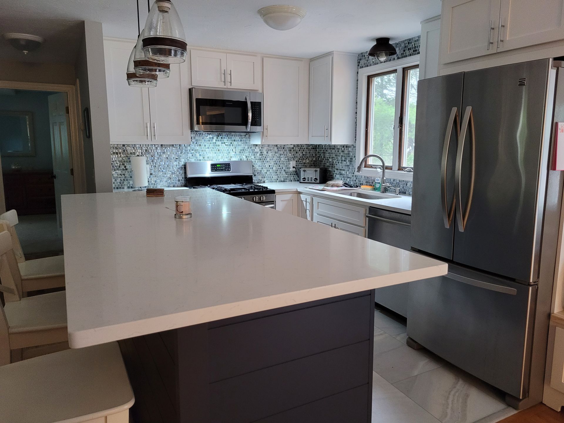 A kitchen with a large island and stainless steel appliances