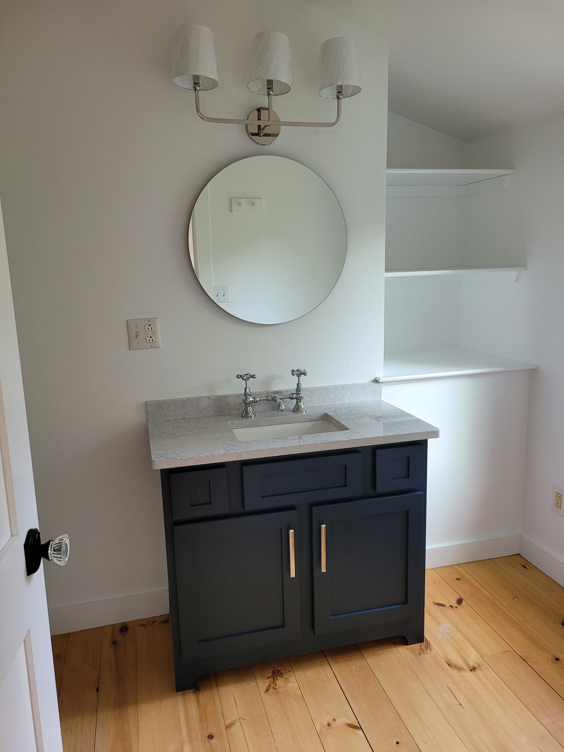 A bathroom with a sink and a mirror on the wall.