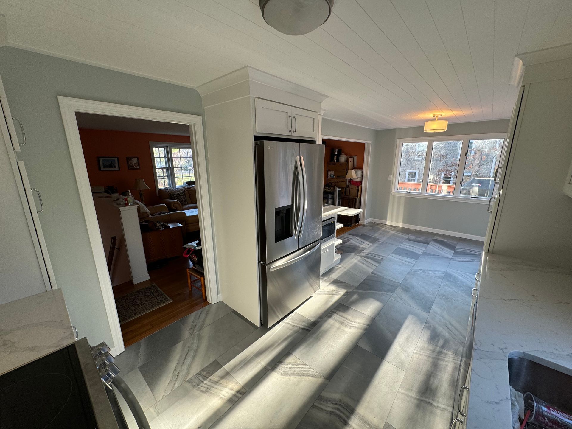 A kitchen with stainless steel appliances and a refrigerator.