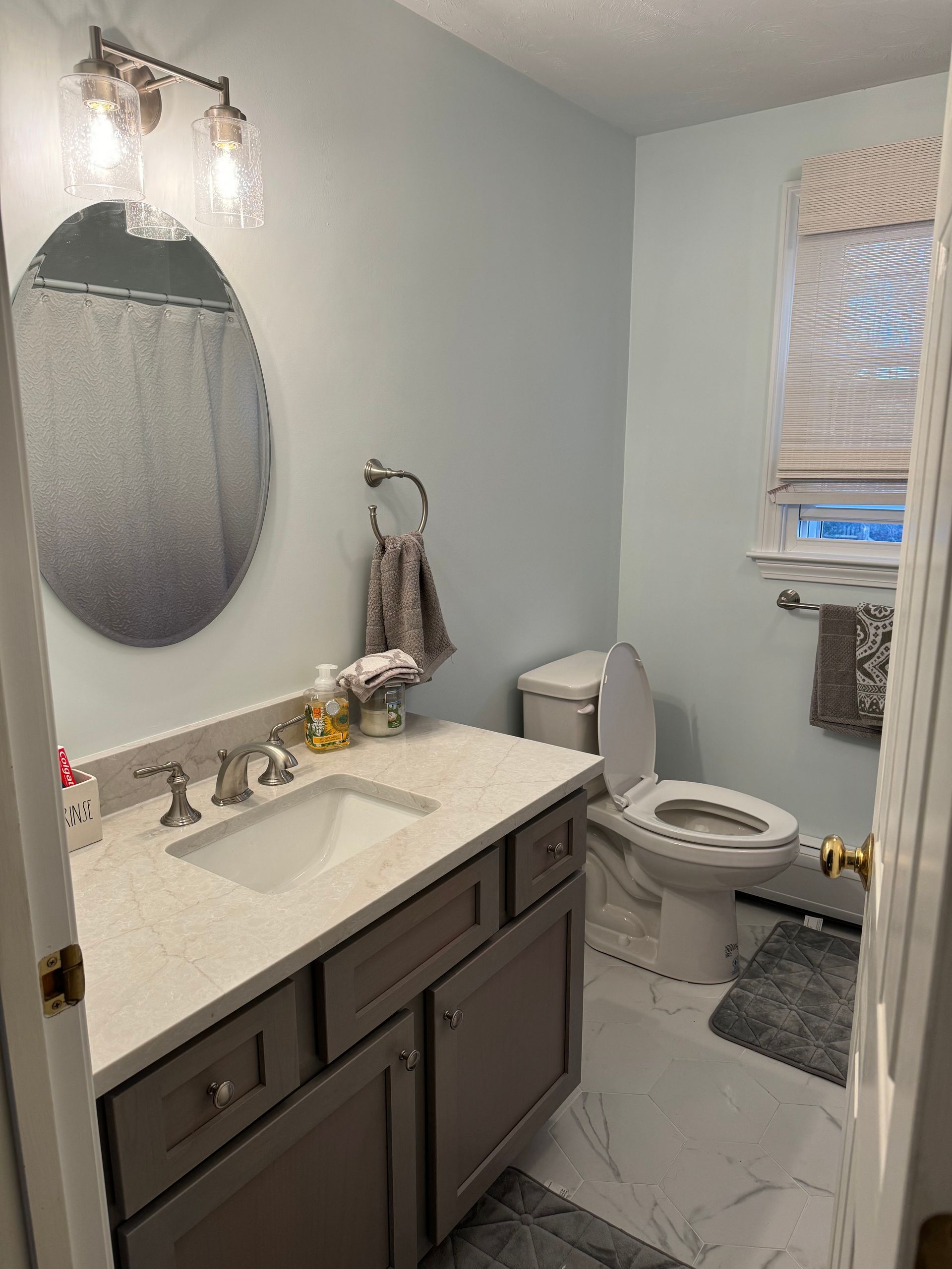 A bathroom with a sink , toilet , and mirror.