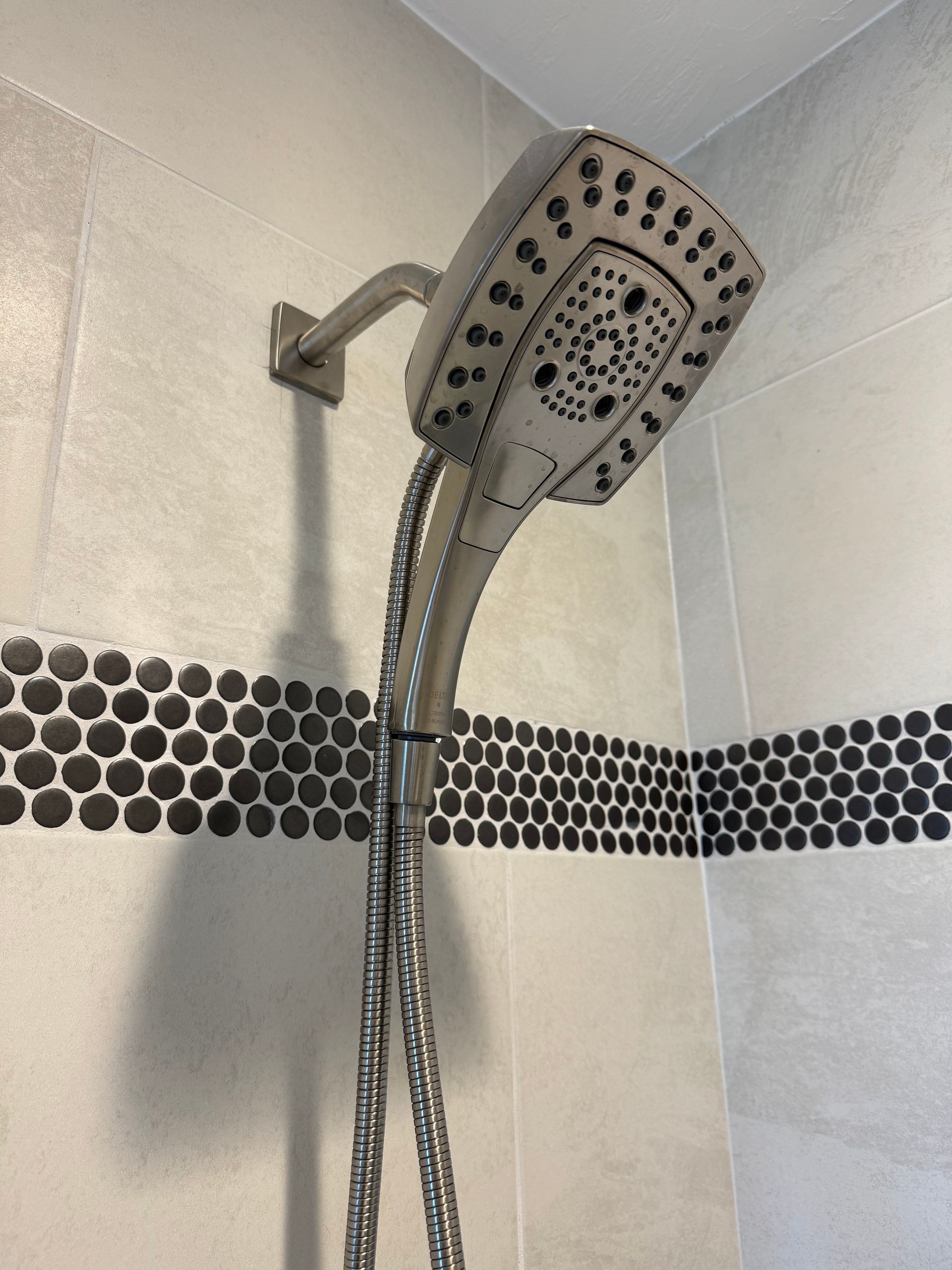 A shower head with a hose attached to it