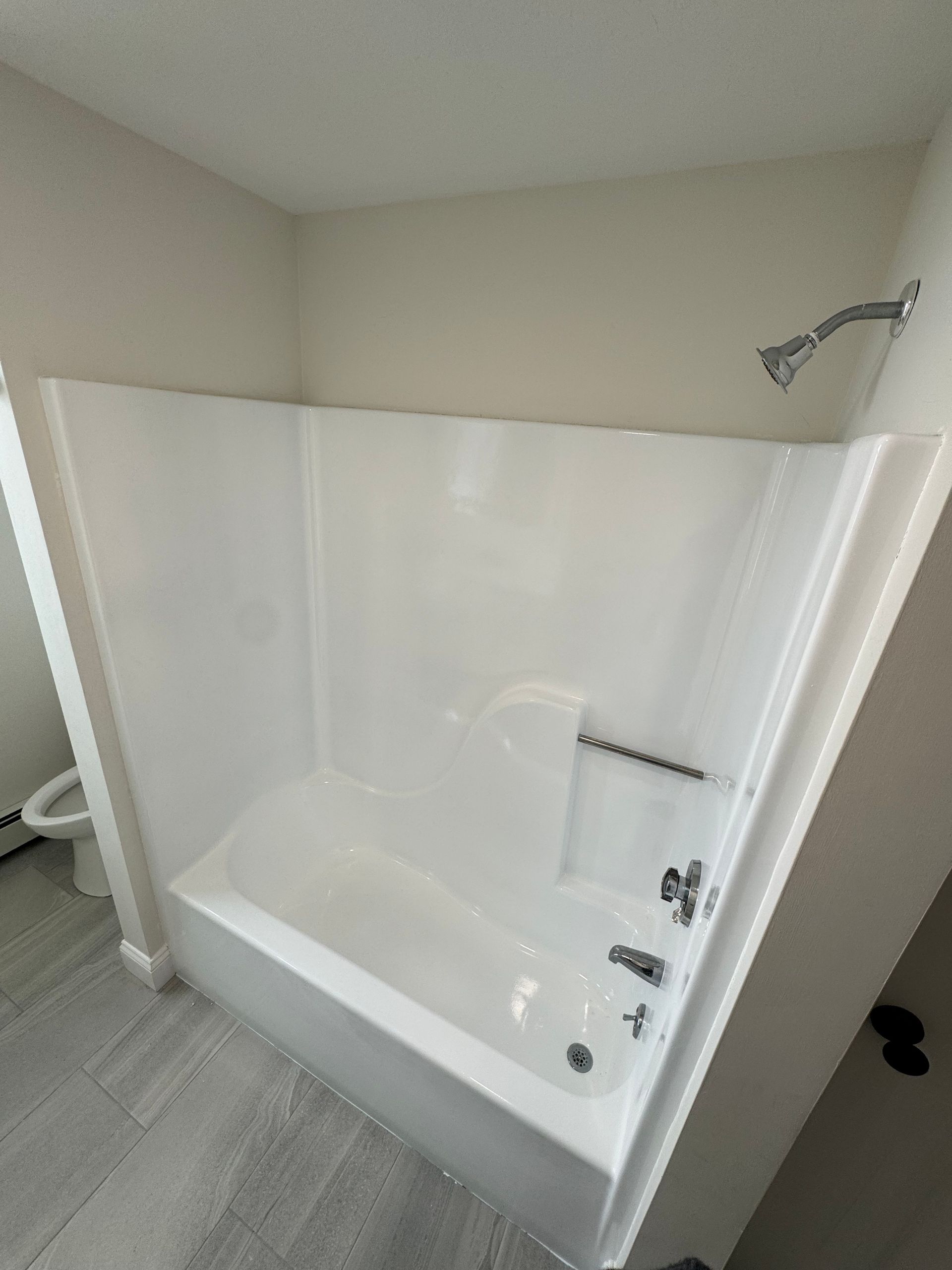 A bathroom with a bathtub and a shower stall.