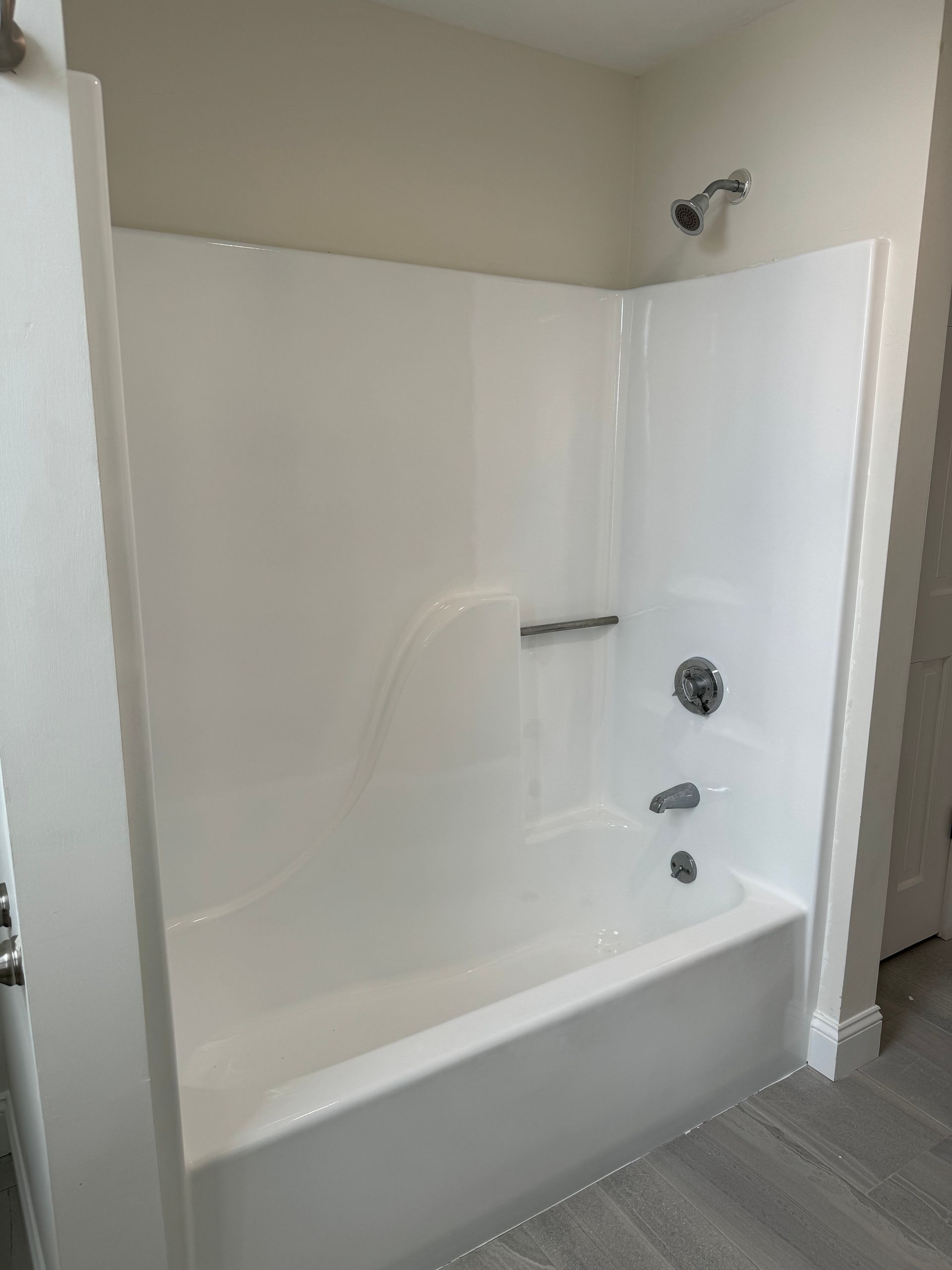 A bathroom with a bathtub and a shower.