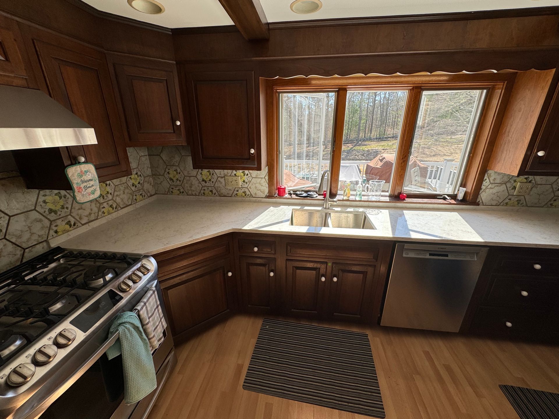 A kitchen with stainless steel appliances and wooden cabinets