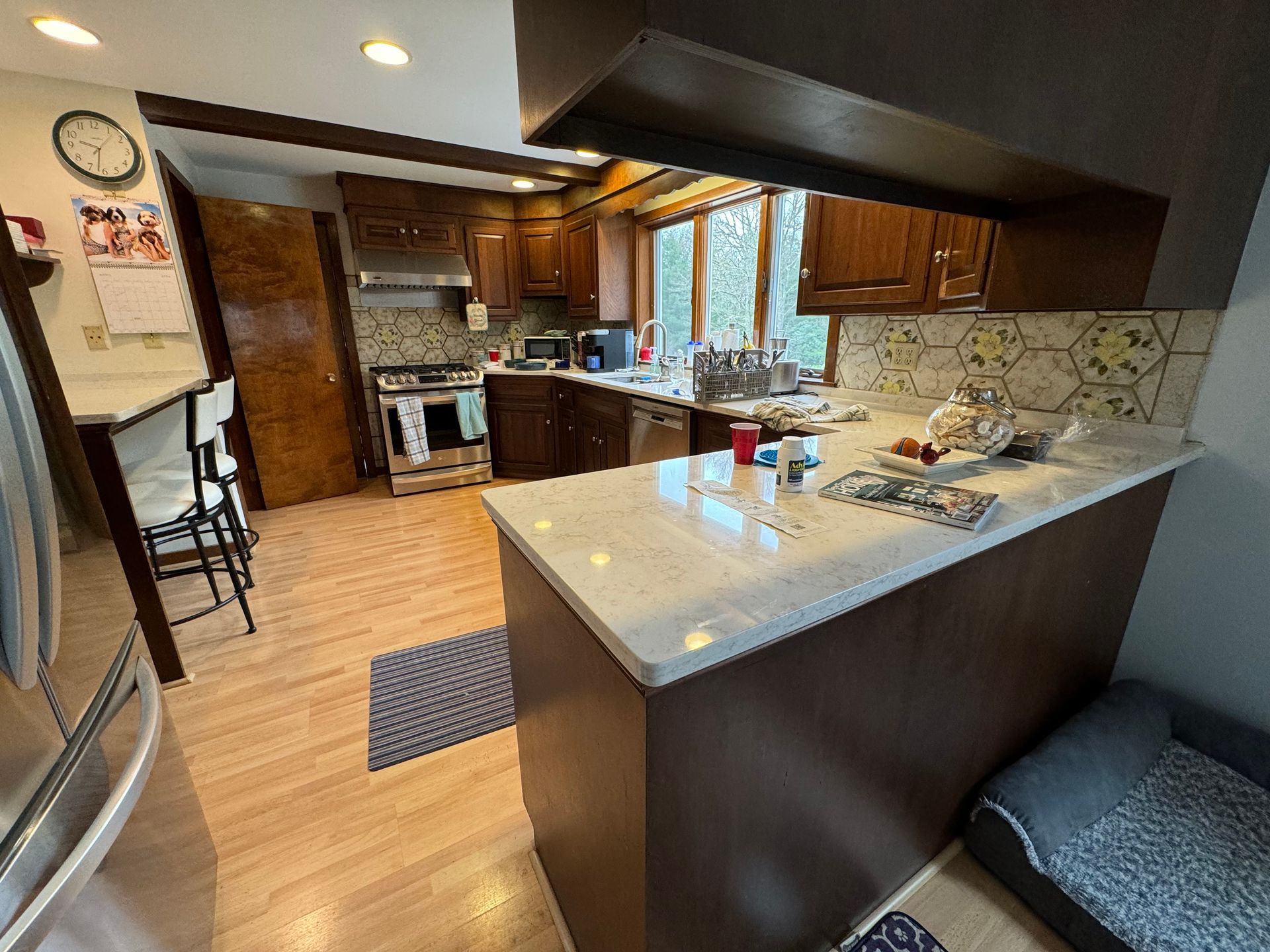A kitchen with stainless steel appliances and wooden cabinets