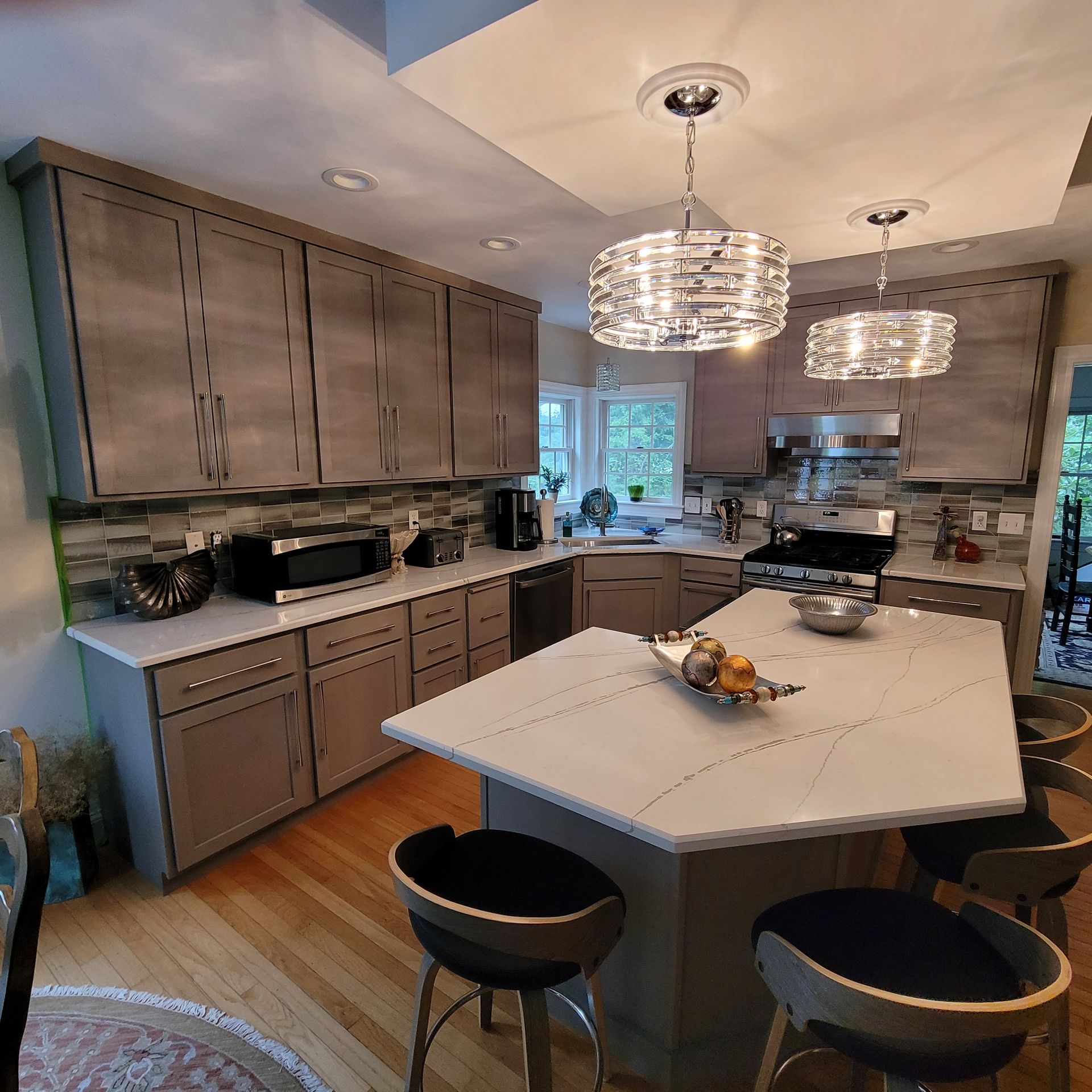 A kitchen with a large island and stools