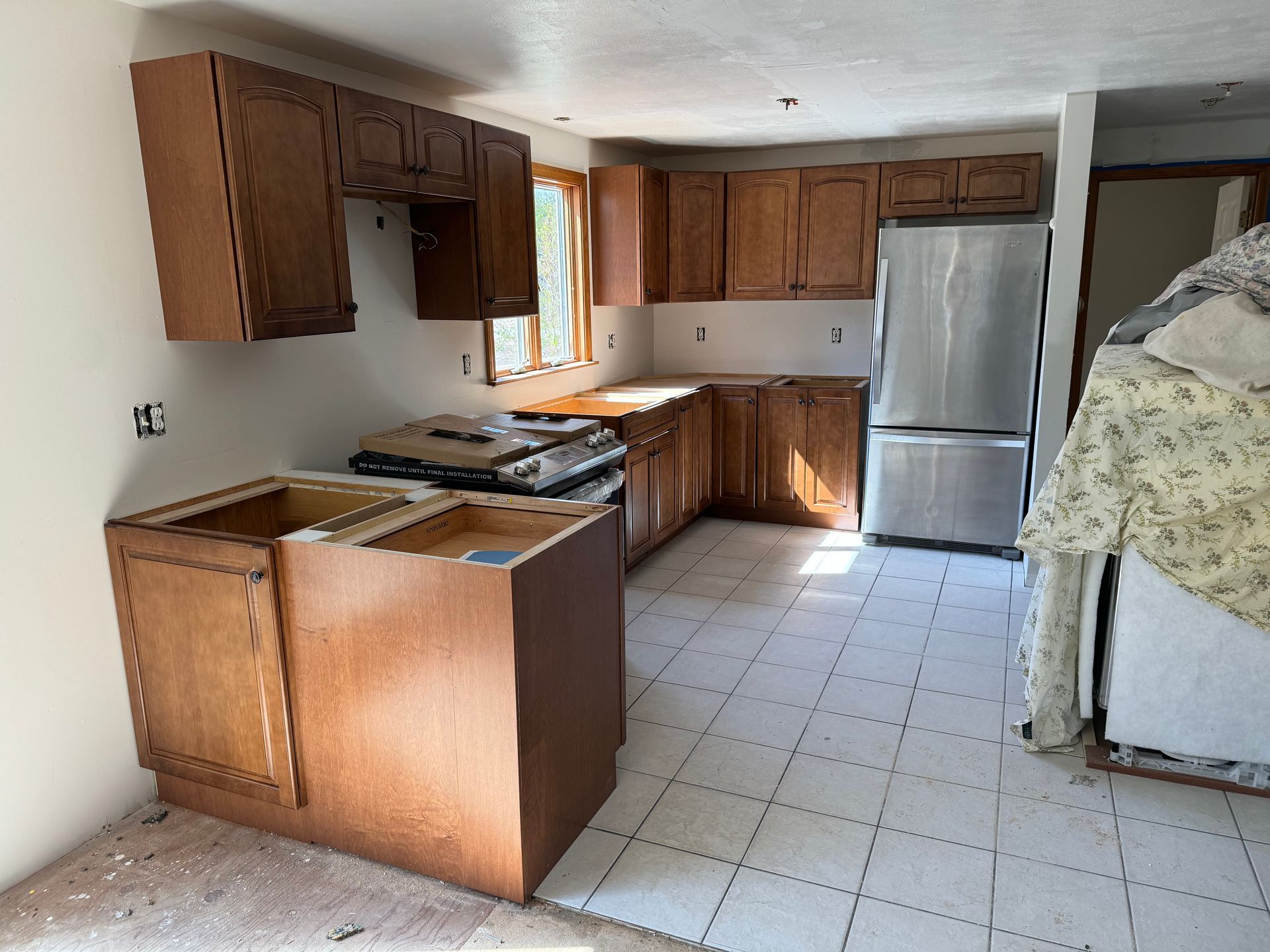 A kitchen with stainless steel appliances and wooden cabinets
