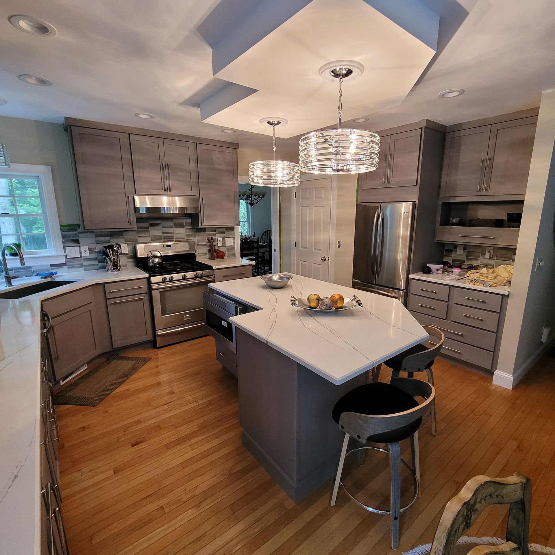 A kitchen with stainless steel appliances and wooden cabinets