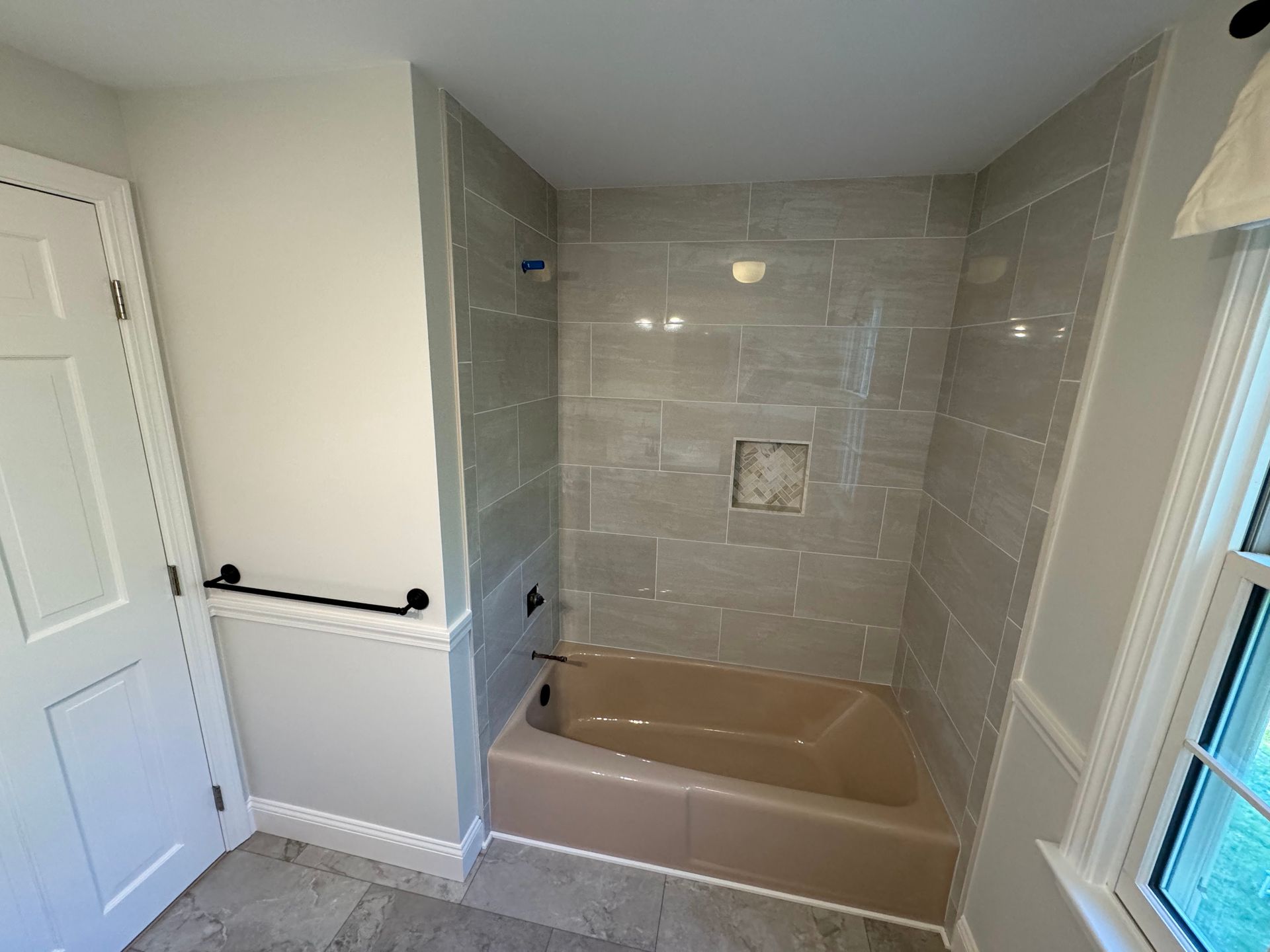 A bathroom with a tub and a shower.