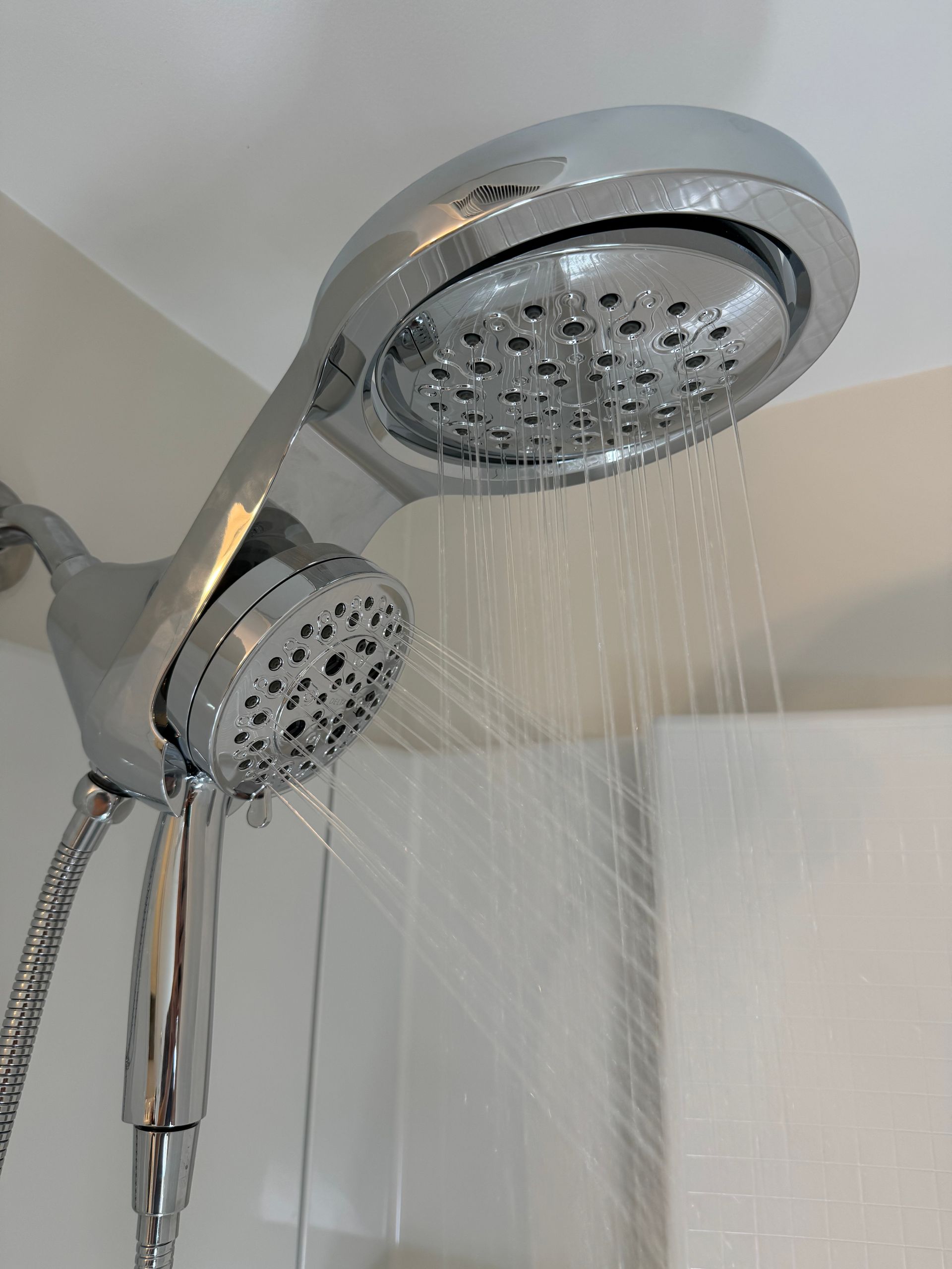 A close up of a shower head with water coming out of it.