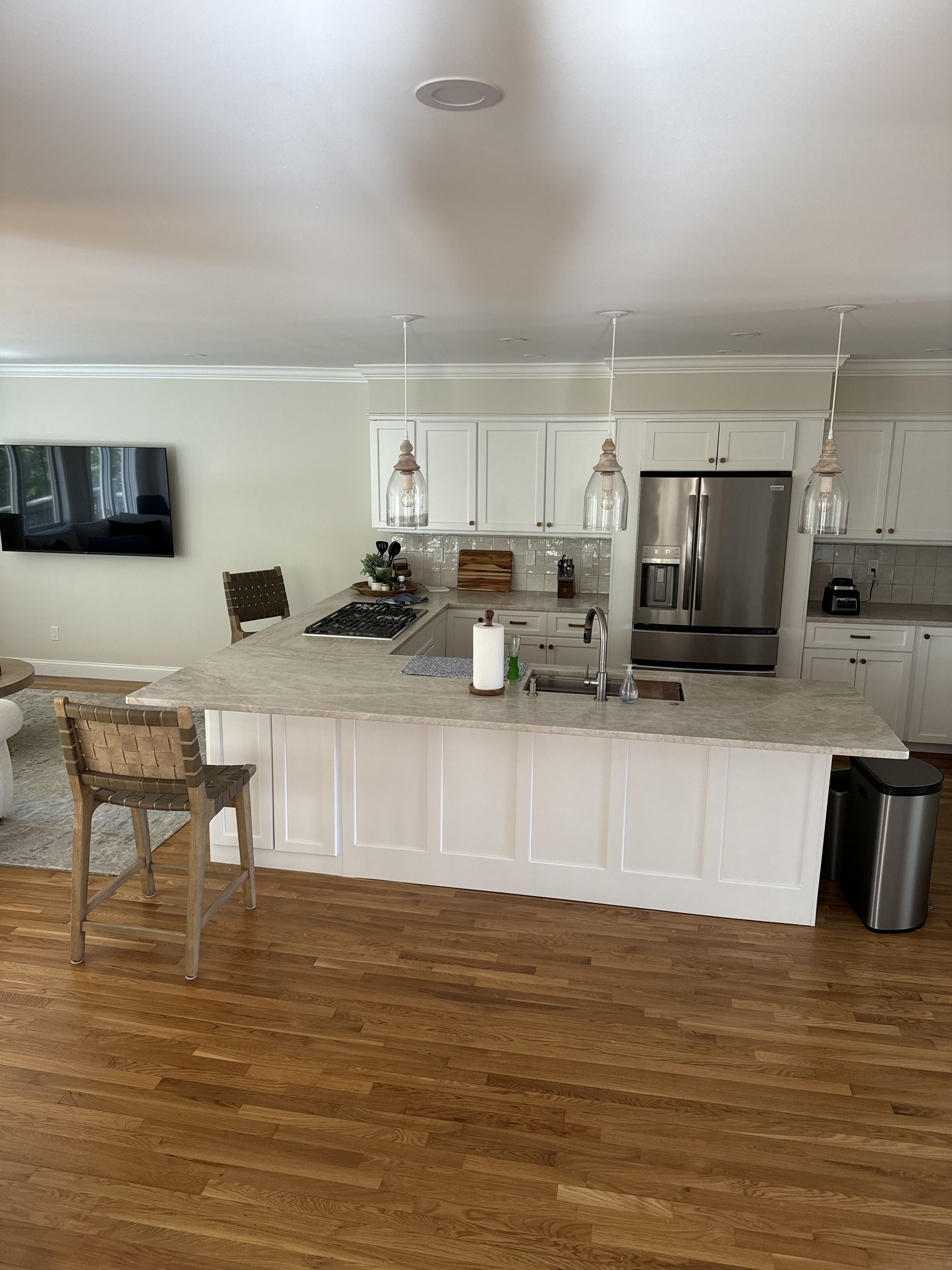 A kitchen with white cabinets and stainless steel appliances