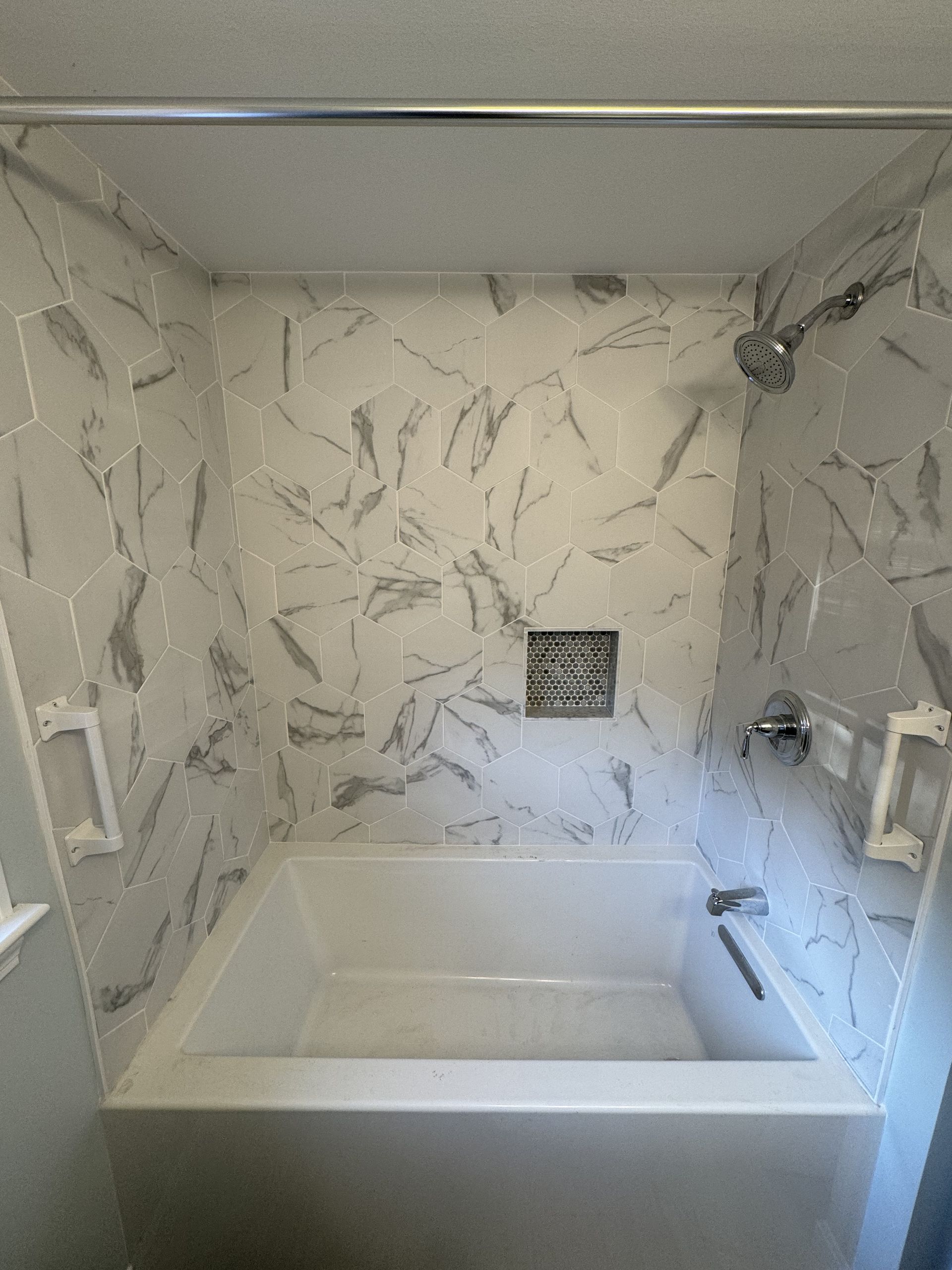 A bathroom with a bathtub and a shower.