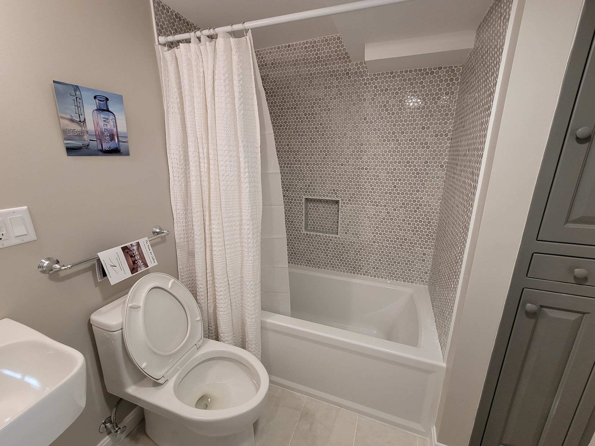 A bathroom with a toilet , sink , tub and shower.