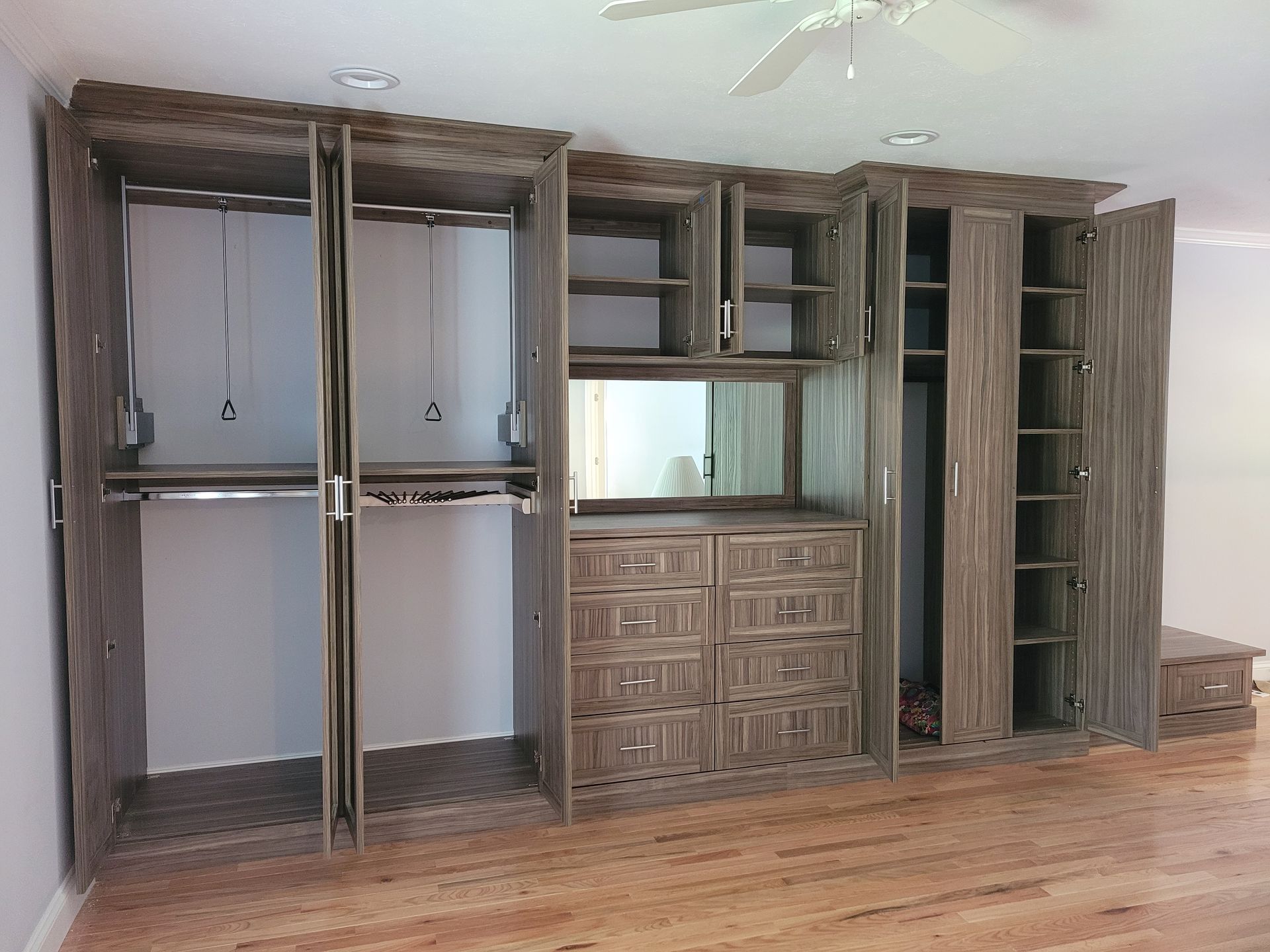 A large closet with lots of shelves and drawers